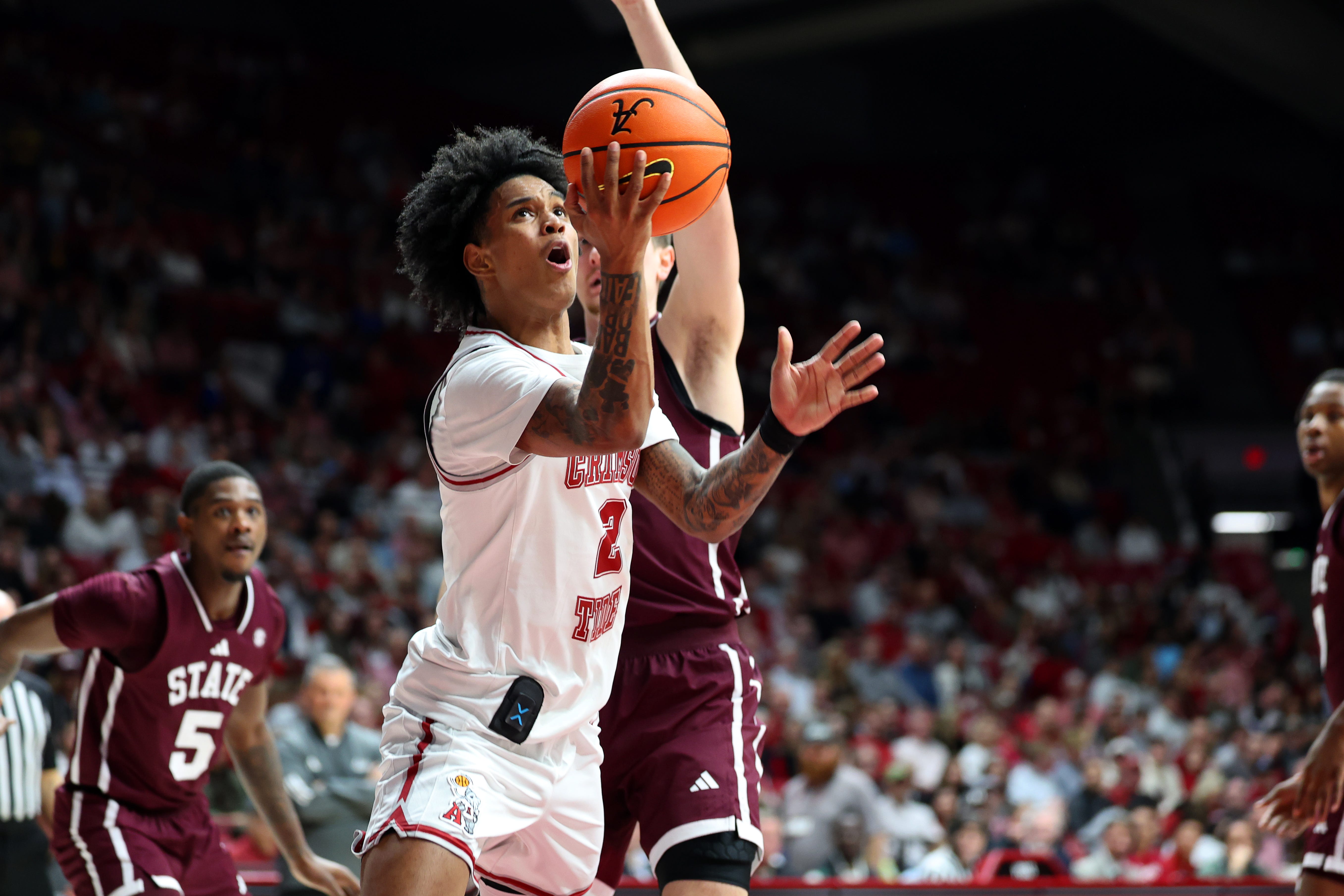 Feb 25, 2026; Tuscaloosa, Alabama, USA; Alabama Crimson Tide guard Aden Holloway (2) drives to the basket during the first half against the Mississippi State Bulldogs at Coleman Coliseum. Mandatory Credit: David Leong-Imagn Images