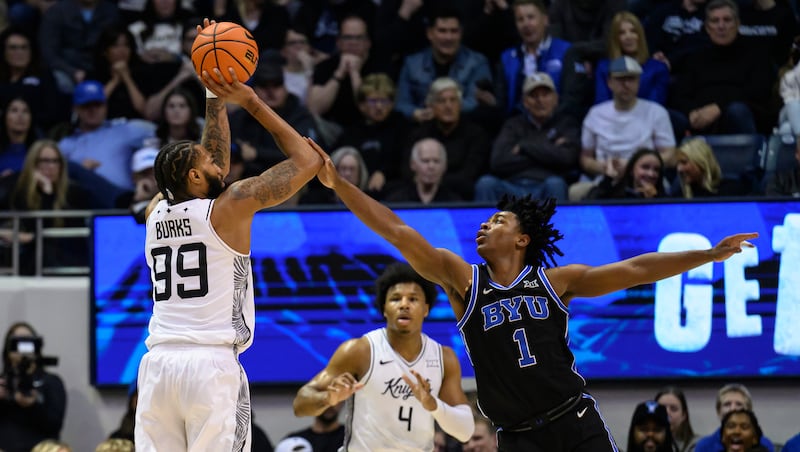 UCF forward Jordan Burks (99) shoots over BYU guard Robert Wright III (1) during the first half an NCAA college basketball game, Tuesday, Feb. 24, 2026, in Provo, Utah.