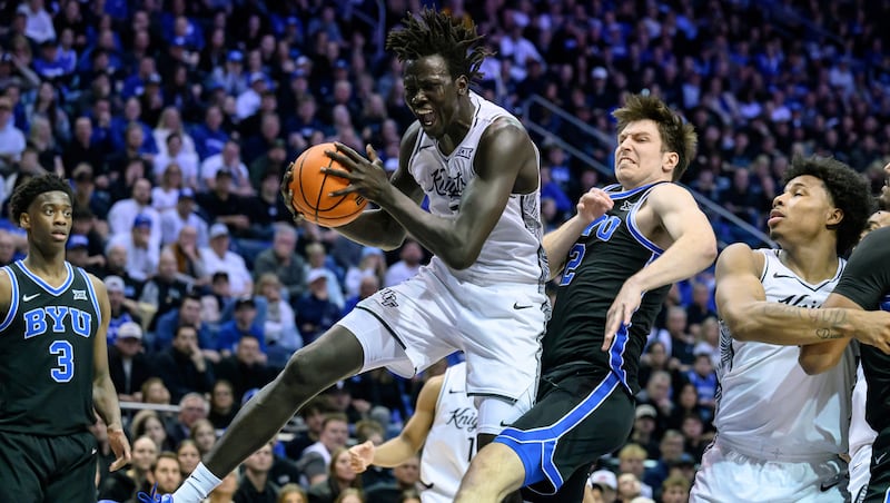 UCF center John Bol, center left wrestles a rebound away from BYU forward Tyler Mrus, center right, during the first half an NCAA college basketball game, Tuesday, Feb. 24, 2026, in Provo, Utah.