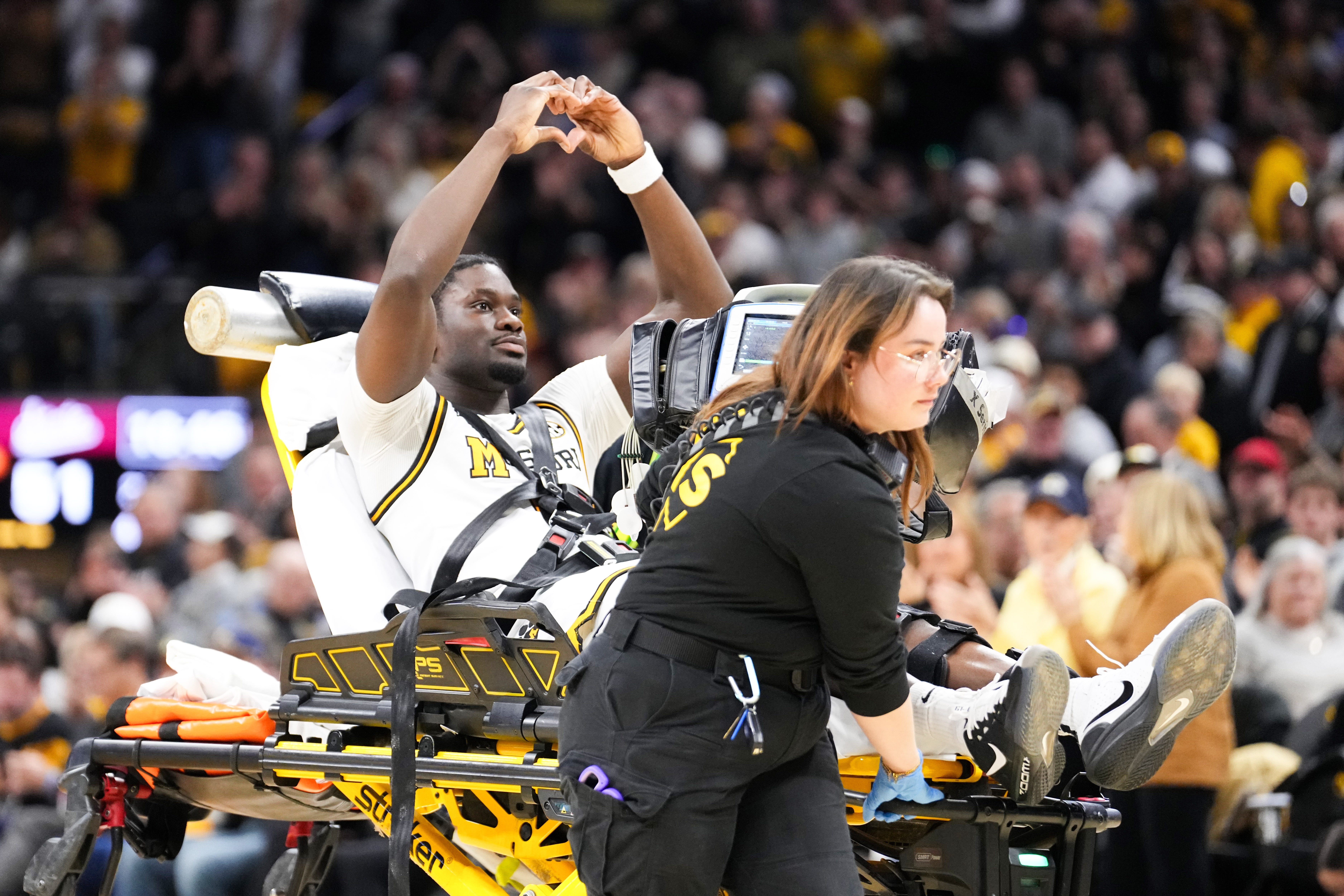 Jan 31, 2026; Columbia, Missouri, USA; Missouri Tigers guard Annor Boateng (6) signals to fans as he is carted off the court by medical personnel after an injury against the Mississippi State Bulldogs during the second half of the game at Mizzou Arena. Mandatory Credit: Denny Medley-Imagn Images