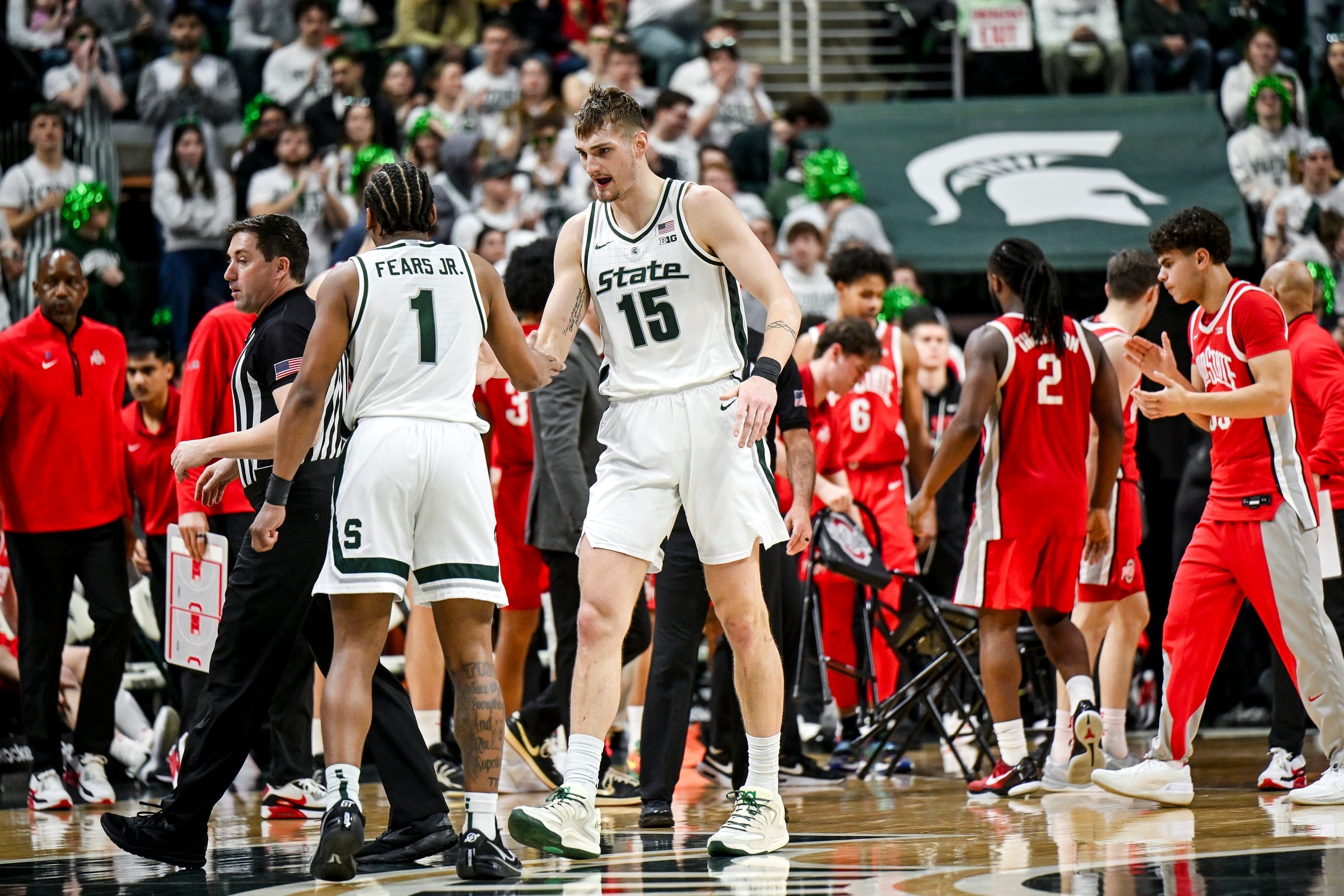 Michigan State's Carson Cooper, right, slaps hands with Jeremy Fears Jr. after a timeout during the second half in the game against an Ohio State on Sunday, Feb. 22, 2026, at the Breslin Center in East Lansing.