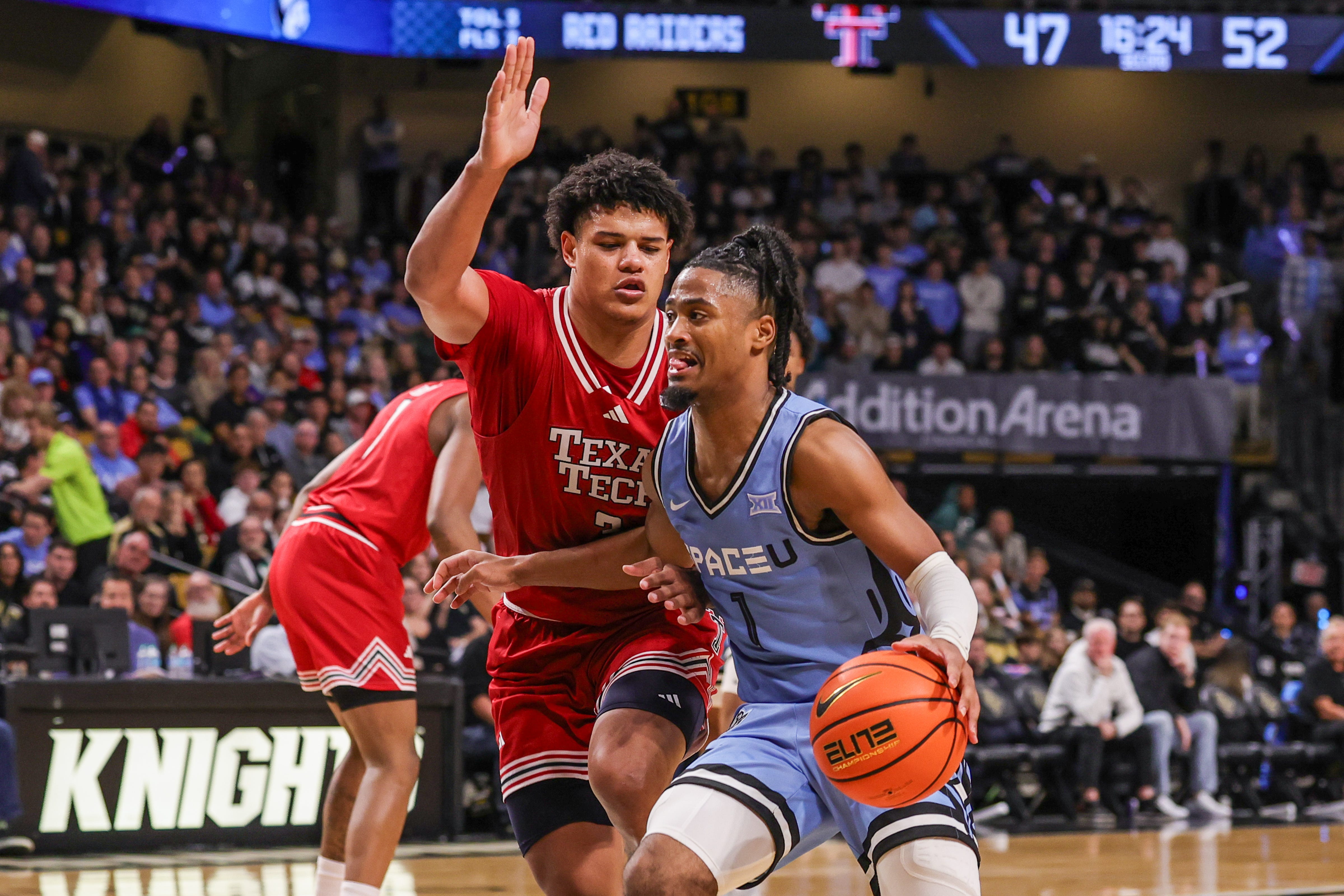 Jan 31, 2026; Orlando, Florida, USA; UCF Knights guard Themus Fulks (1) drives around Texas Tech Red Raiders forward Lejuan Watts (3) during the second half at Addition Financial Arena. Mandatory Credit: Mike Watters-Imagn Images