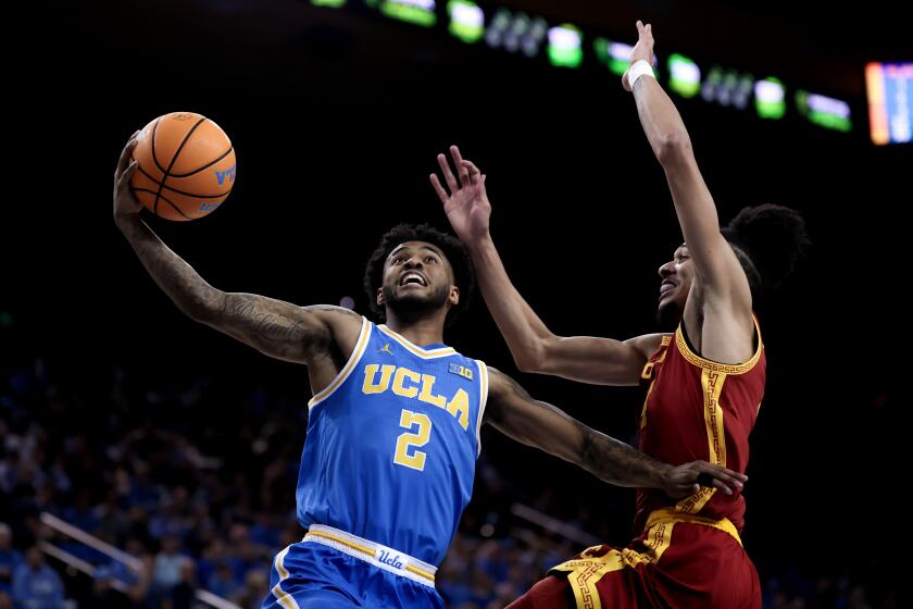 Los Angeles, CA - February 24: UCLA Bruins guard Donovan Dent (2) drives to the basket against USC Trojans forward Chad Baker-Mazara (4) during the first half of an NCAA mens basketball game at Pauley Pavilion on Tuesday, Feb. 24, 2026 in Los Angeles, CA. (Eric Thayer / Los Angeles Times)