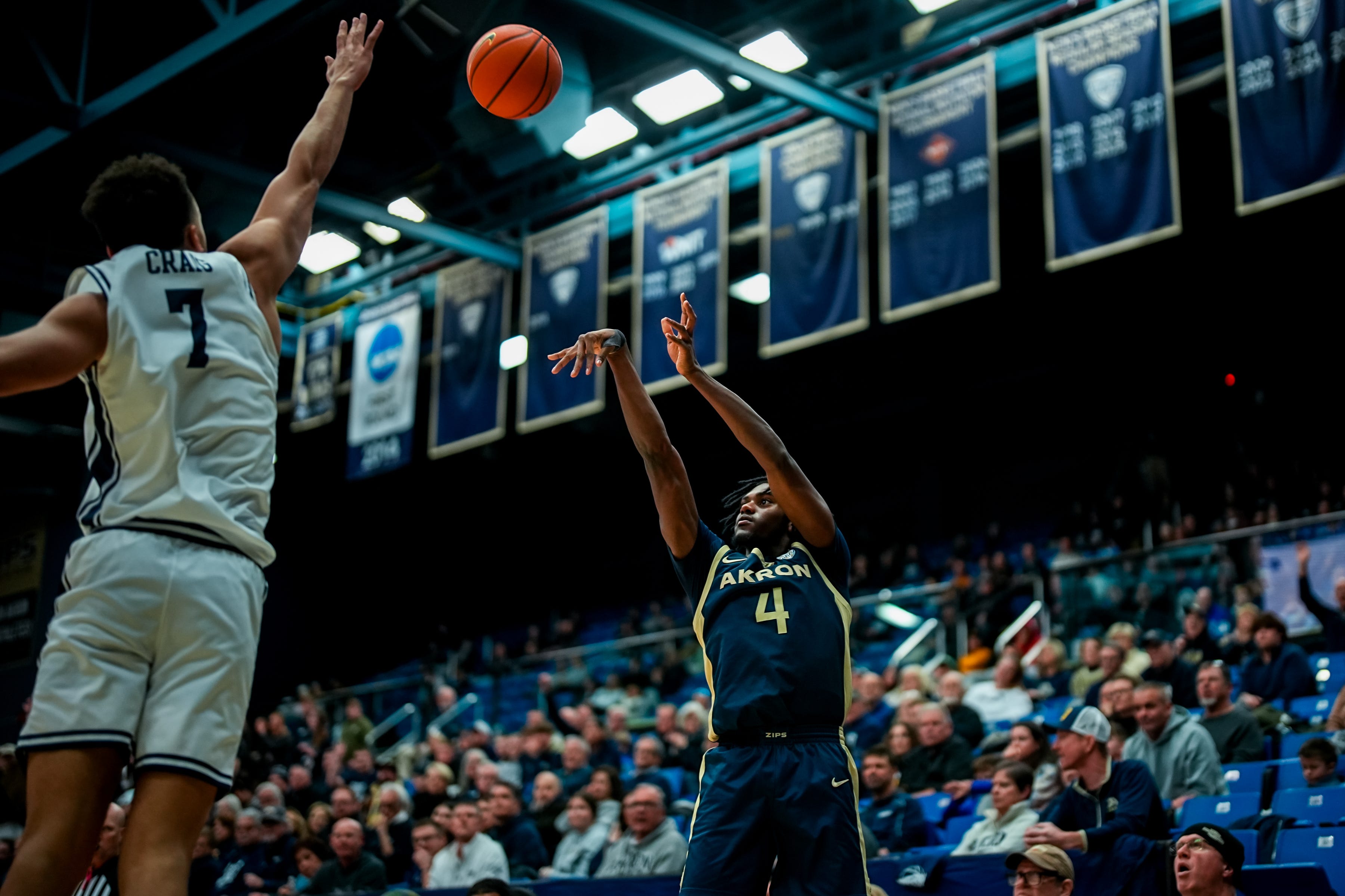 University of Akron’s Eric Mahaffey (4) shoots over University of Toledo’s Sean Craig (7), Jan. 27, 2026, at James A Rhodes Arena in Akron, Ohio.