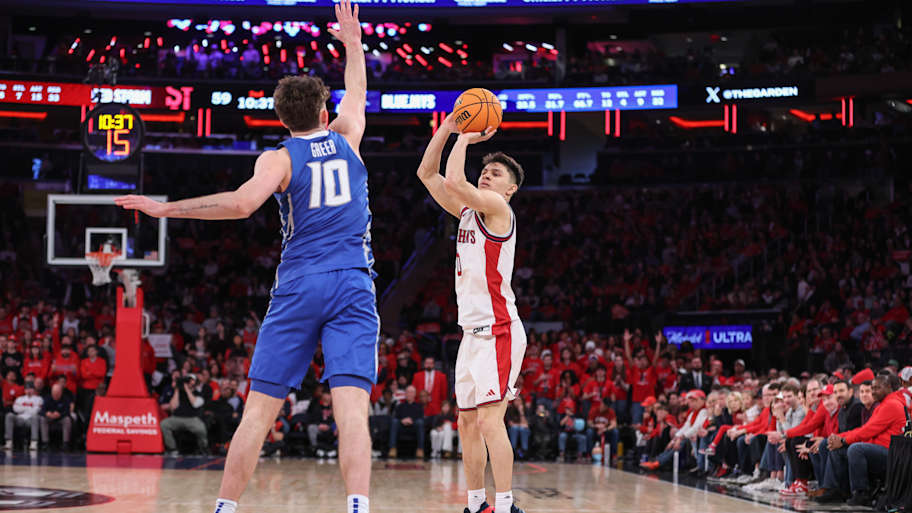 St. John's Red Storm guard Dylan Darling (0) takes a three-point shot past Creighton Bluejays guard Hudson Greer (10).