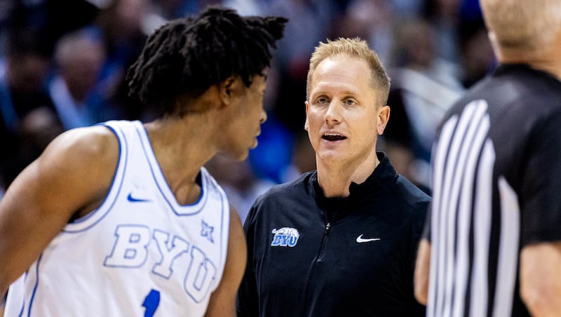 BYU head coach Kevin Young talks with guard Robert Wright III (1) at the end of a timeout during an NCAA basketball game against Iowa State held at the Marriott Center in Provo on Saturday, Feb. 21, 2026.