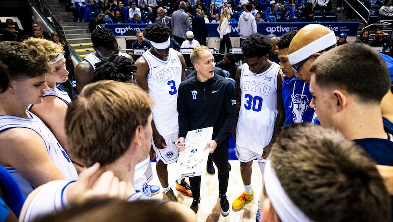 BYU coach Kevin Young talks with his players before a game against Holy Cross at the Marriott Center in Provo on Saturday, Nov. 8, 2025.