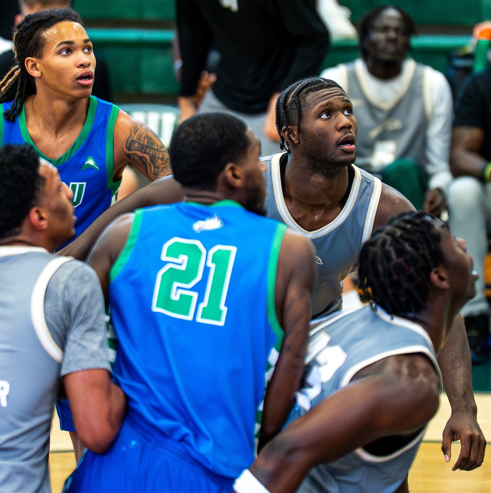 Jacksonville University forwards Donovan Rivers (33) and Allen Udemadu (top right) try to get rebounding position against Tristen Guillouette of Florida Gulf Coast (21) during their game on Jan. 31 at Swisher Gym. Gulf Coast won 68-49.
