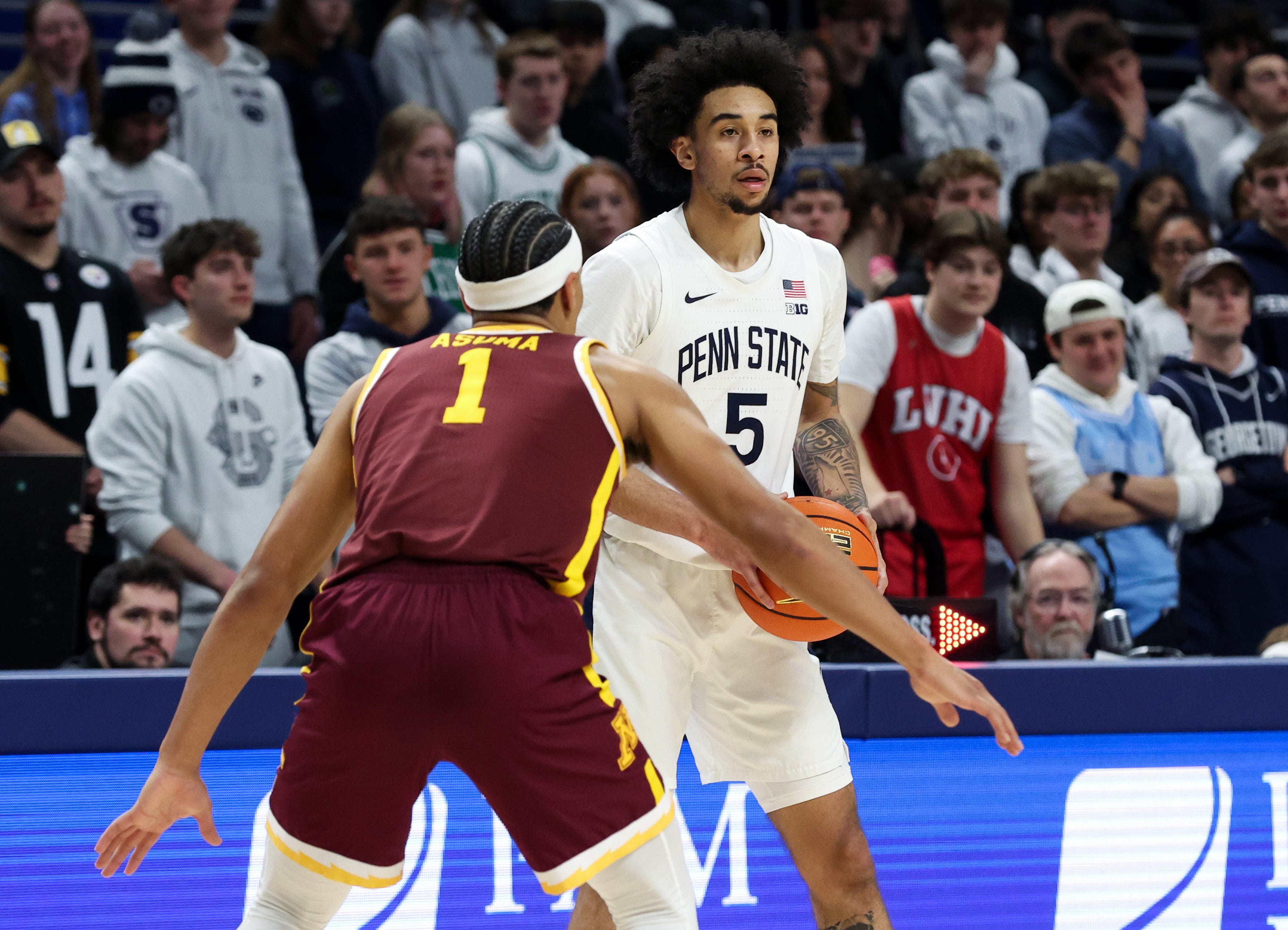Feb 1, 2026; University Park, Pennsylvania, USA; Penn State Nittany Lions guard Freddie Dilione V (5) holds the ball as Minnesota Golden Gophers guard Isaac Asuma (1) defends during the first half at Bryce Jordan Center. Mandatory Credit: Matthew O'Haren-Imagn Images