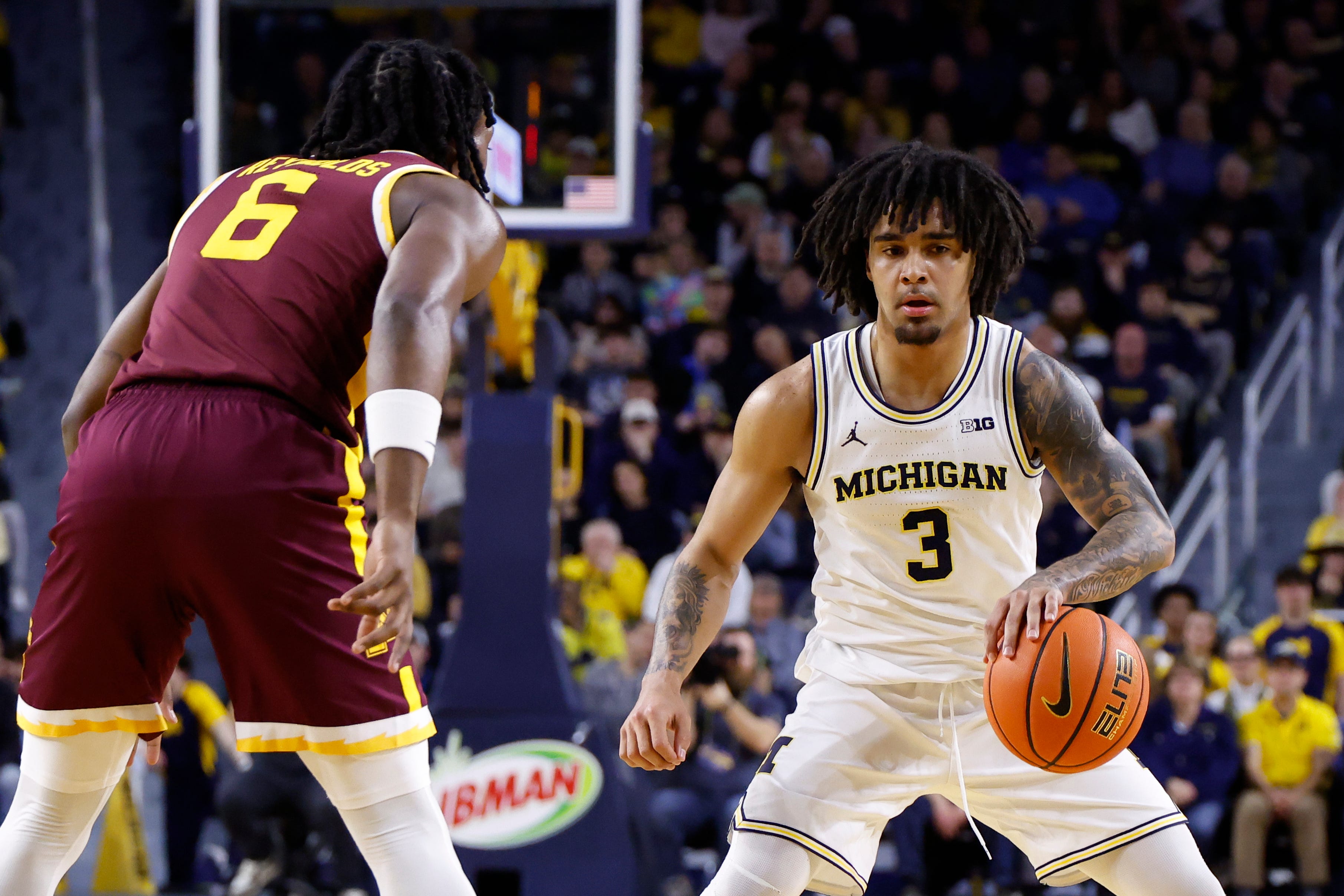 Michigan Wolverines guard Elliot Cadeau (3) dribbles against Minnesota Golden Gophers guard Langston Reynolds (6) in the first half at Crisler Center in Ann Arbor on Tuesday, Feb. 24, 2026.