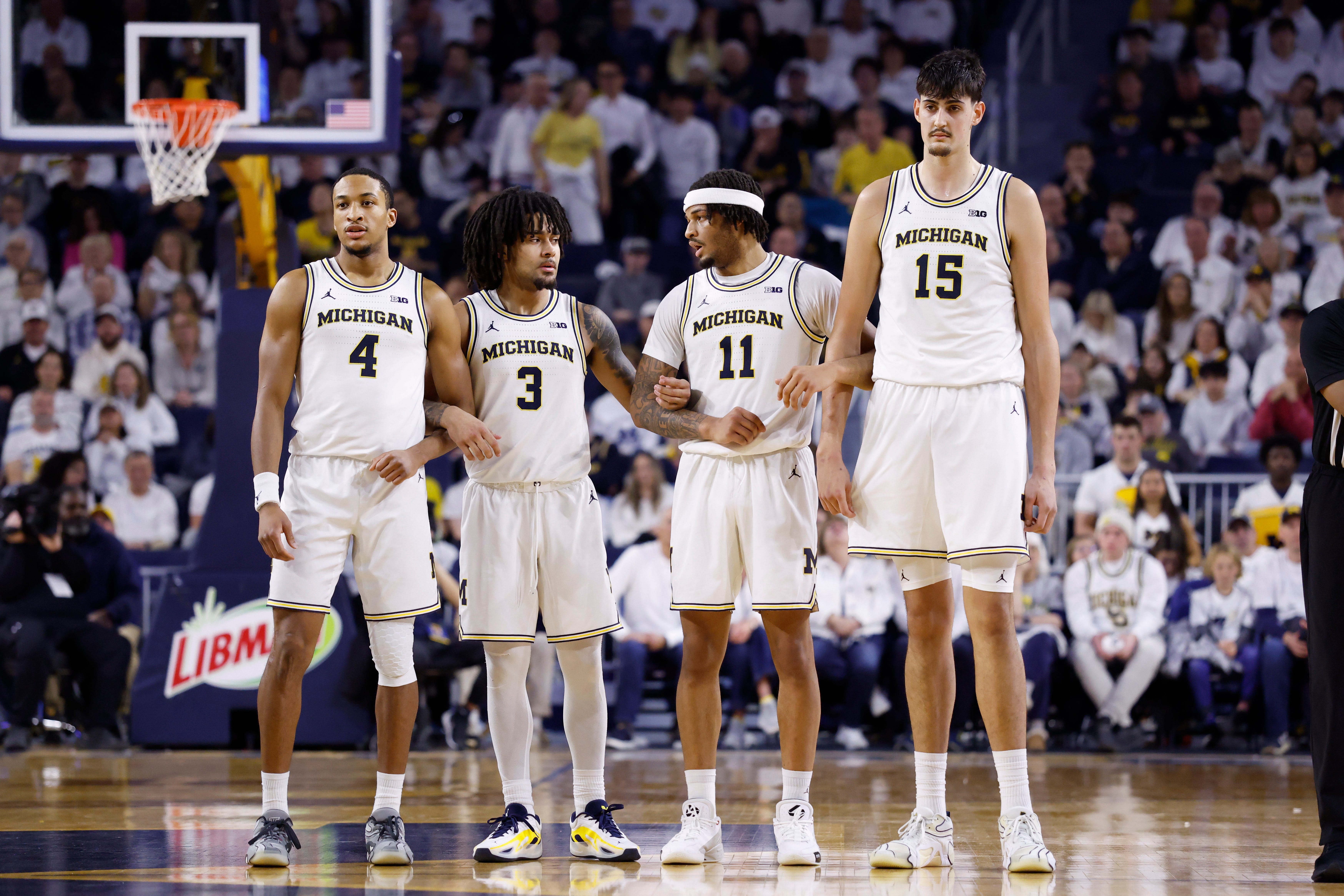 Michigan's Nimari Burnett (4), Elliot Cadeau (3), Roddy Gayle Jr. (11) and Aday Mara (15) lock arms during the first half against UCLA at Crisler Center on Feb. 14, 2026 in Ann Arbor.