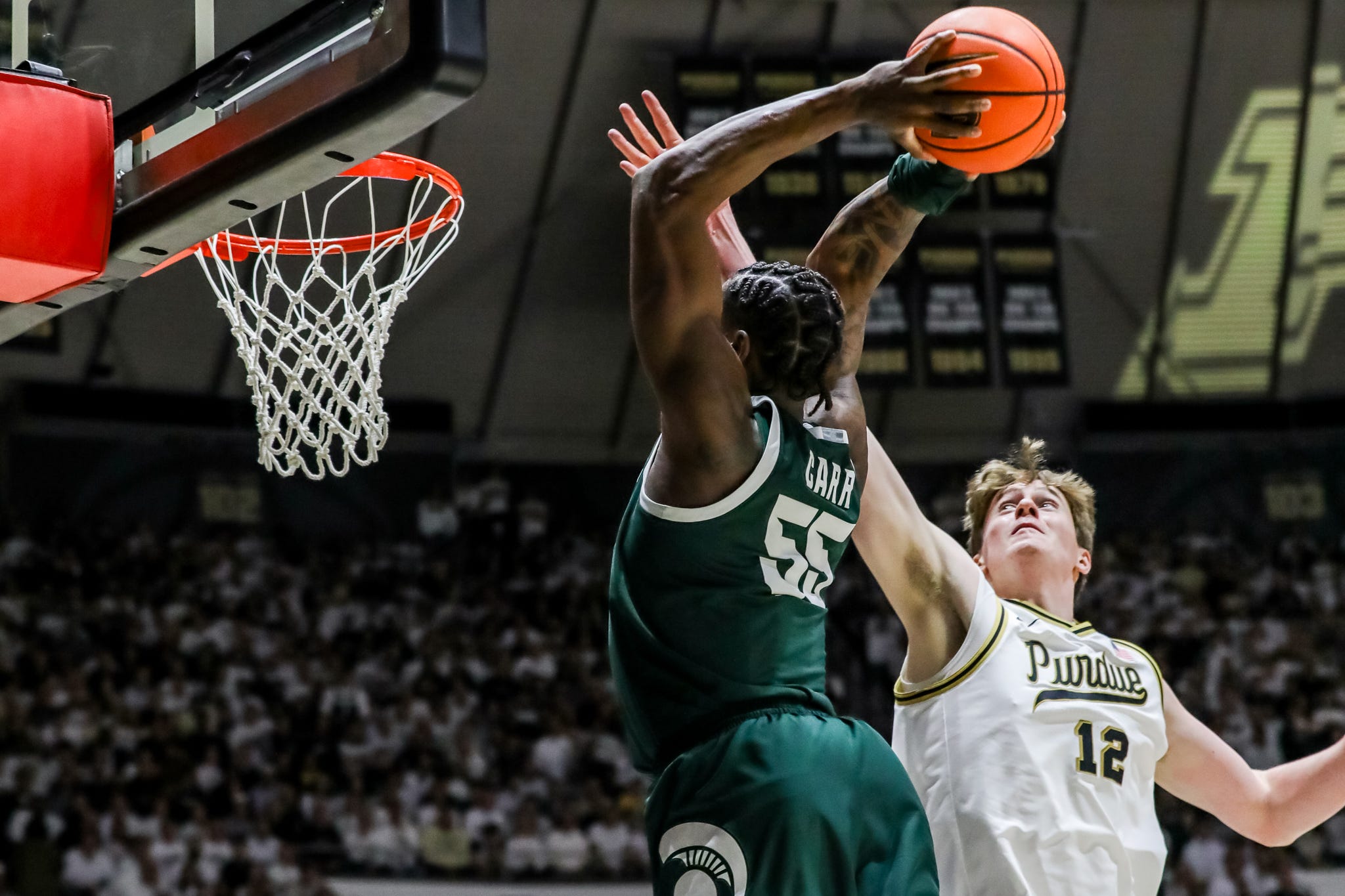 Daniel Jacobsen elevates to try and block Michigan State's Coen Carr from dunking during the first half of Purdue's game against Michigan State on Feb. 26, 2026, at Mackey Arena in West Lafayette, IN.