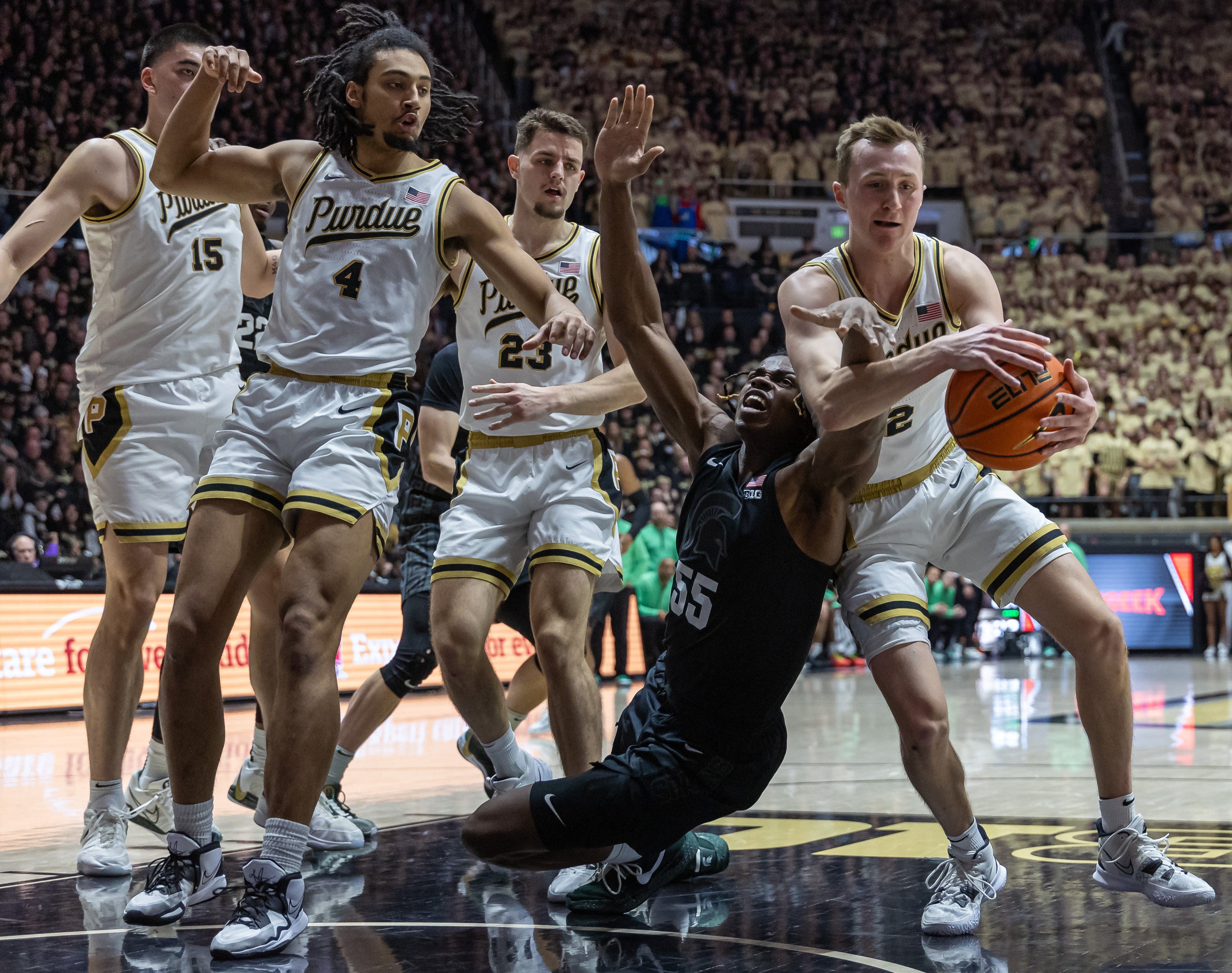 Michigan State forward Coen Carr reaches for the ball against Purdue's Fletcher Loyer during the first half on Saturday, March 2, 2024, in West Lafayette, Indiana.