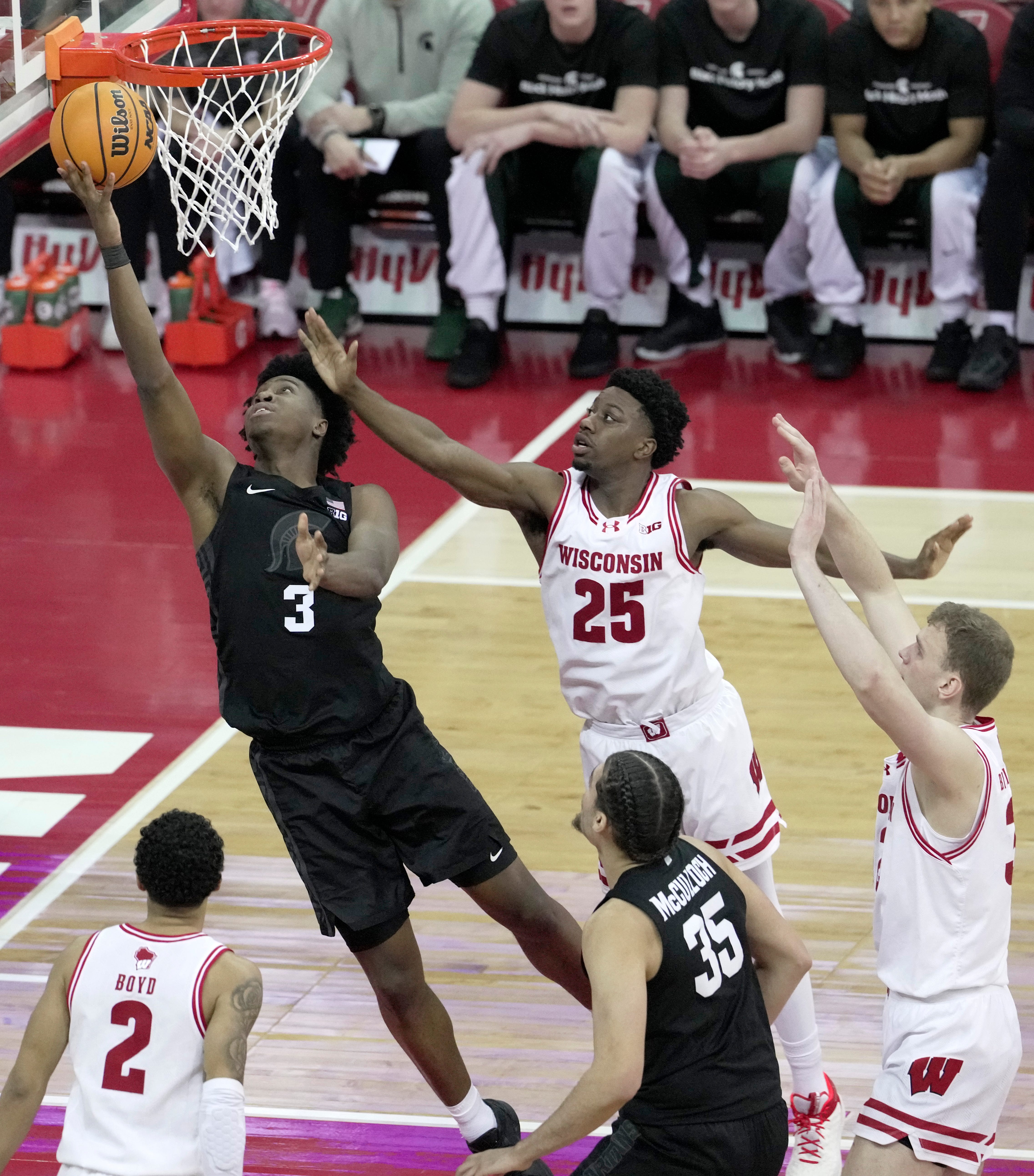 Michigan State forward Cam Ward (3) scores on Wisconsin guard John Blackwell (25) during the second half of their game Friday, February 13, 2026 at the Kohl Center in Madison, Wisconsin. Wisconsin beat 10th ranked Michigan State 92-71.