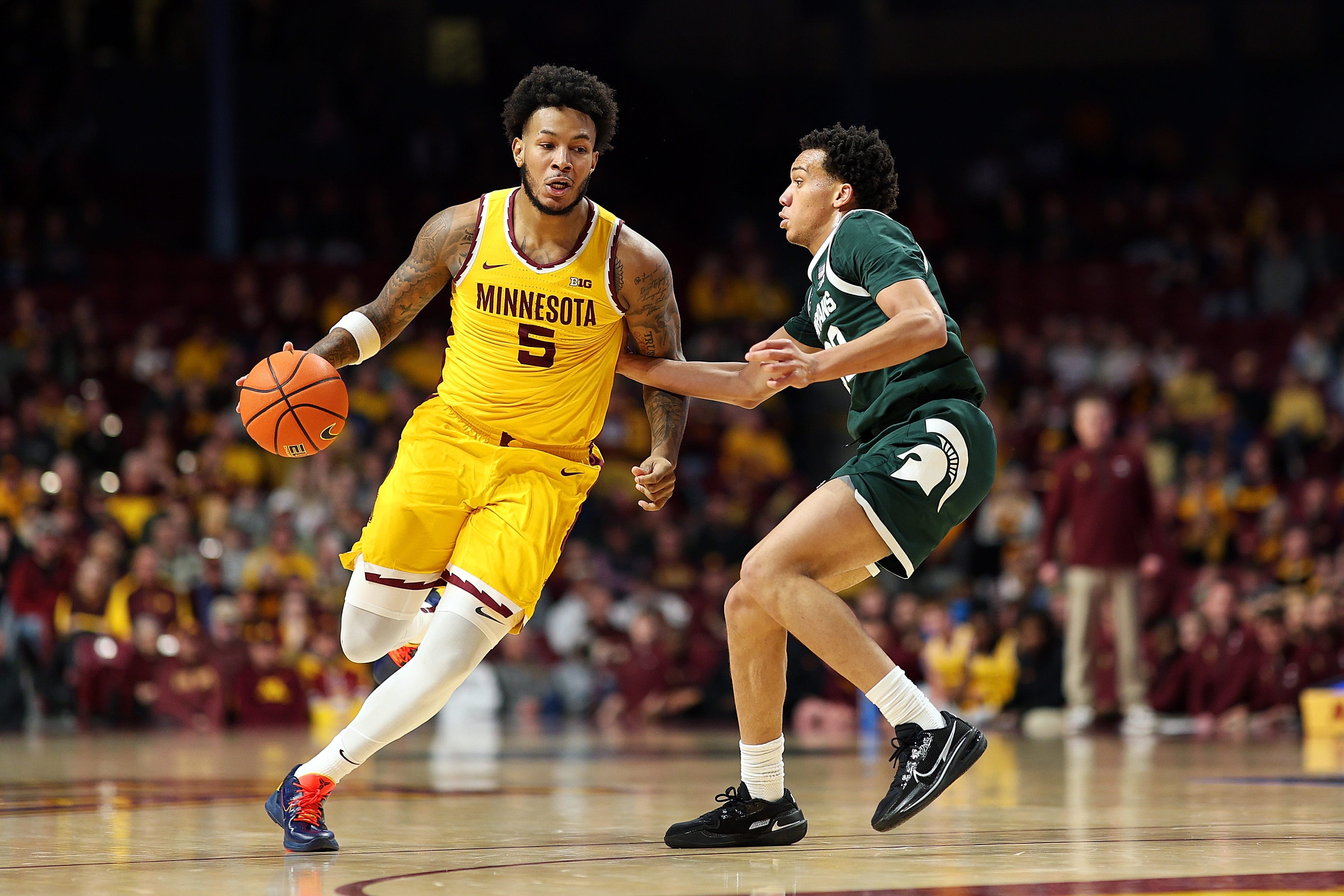 Jaylen Crocker-Johnson of the Minnesota Golden Gophers drives to the basket against Divine Ugochukwu of the Michigan State Spartans in the first half at Williams Arena on Feb. 4, 2026, in Minneapolis.