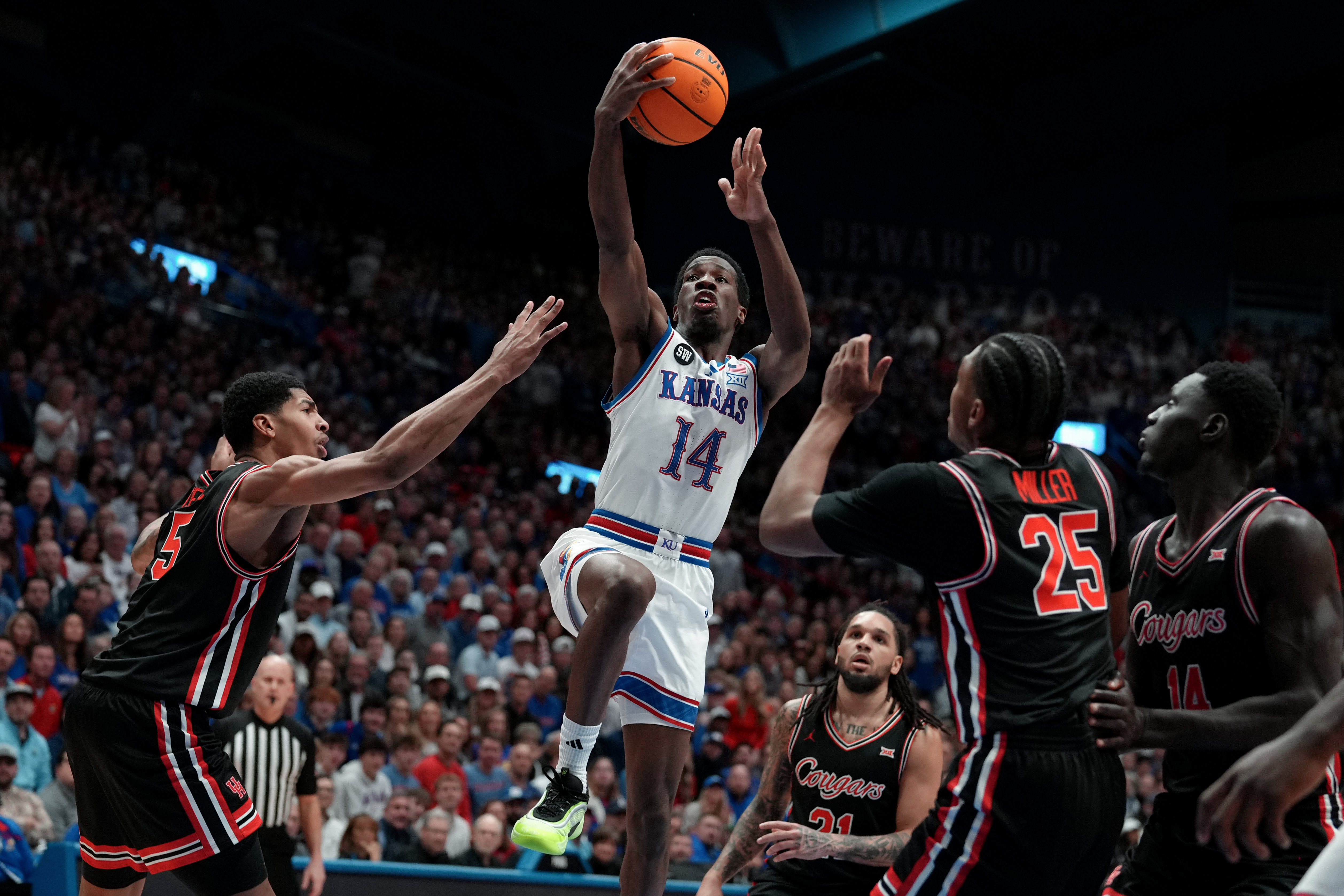 LAWRENCE, KANSAS - FEBRUARY 23: Guard Melvin Council Jr. #14 of the Kansas Jayhawks lays the ball up against forward Chris Cenac Jr. #5, guard Emanuel Sharp #21and guard Mercy Miller #25 of the Houston Cougars in the first half at Allen Fieldhouse on February 23, 2026 in Lawrence, Kansas. (Photo by Ed Zurga/Getty Images)