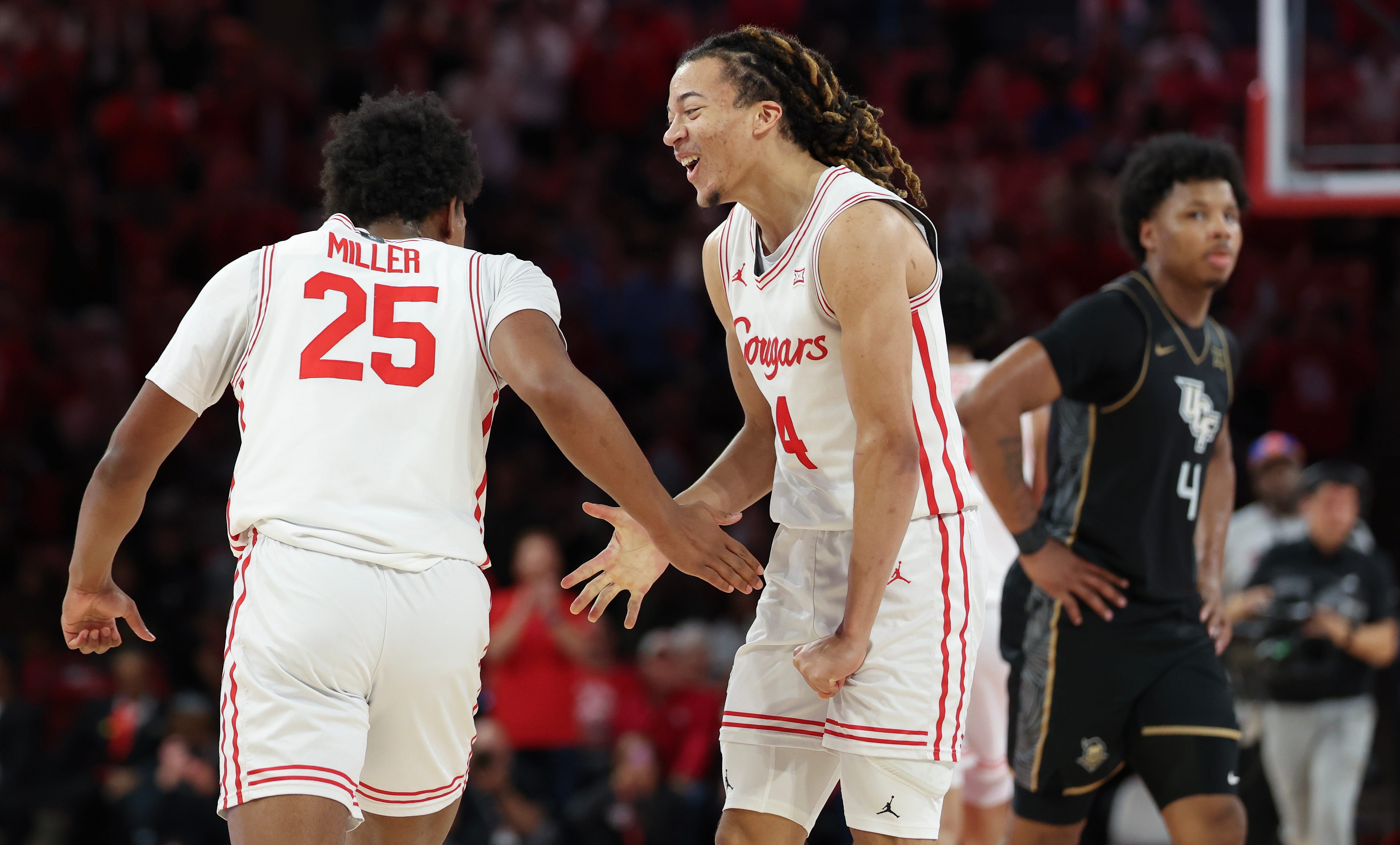 Feb 4, 2026; Houston, Texas, USA; Houston Cougars guard Mercy Miller (25) celebrates a basket by guard Kingston Flemings (4) in the second half against the UCF Knights at Fertitta Center. Mandatory Credit: Thomas Shea-Imagn Images