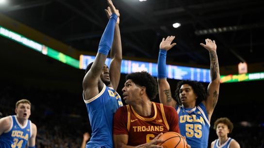 Southern California Trojans forward Jacob Cofie (6) drives to the basket between UCLA Bruins guard Eric Dailey Jr. (3) and guard Skyy Clark (55) during the first half at Pauley Pavilion presented by W...