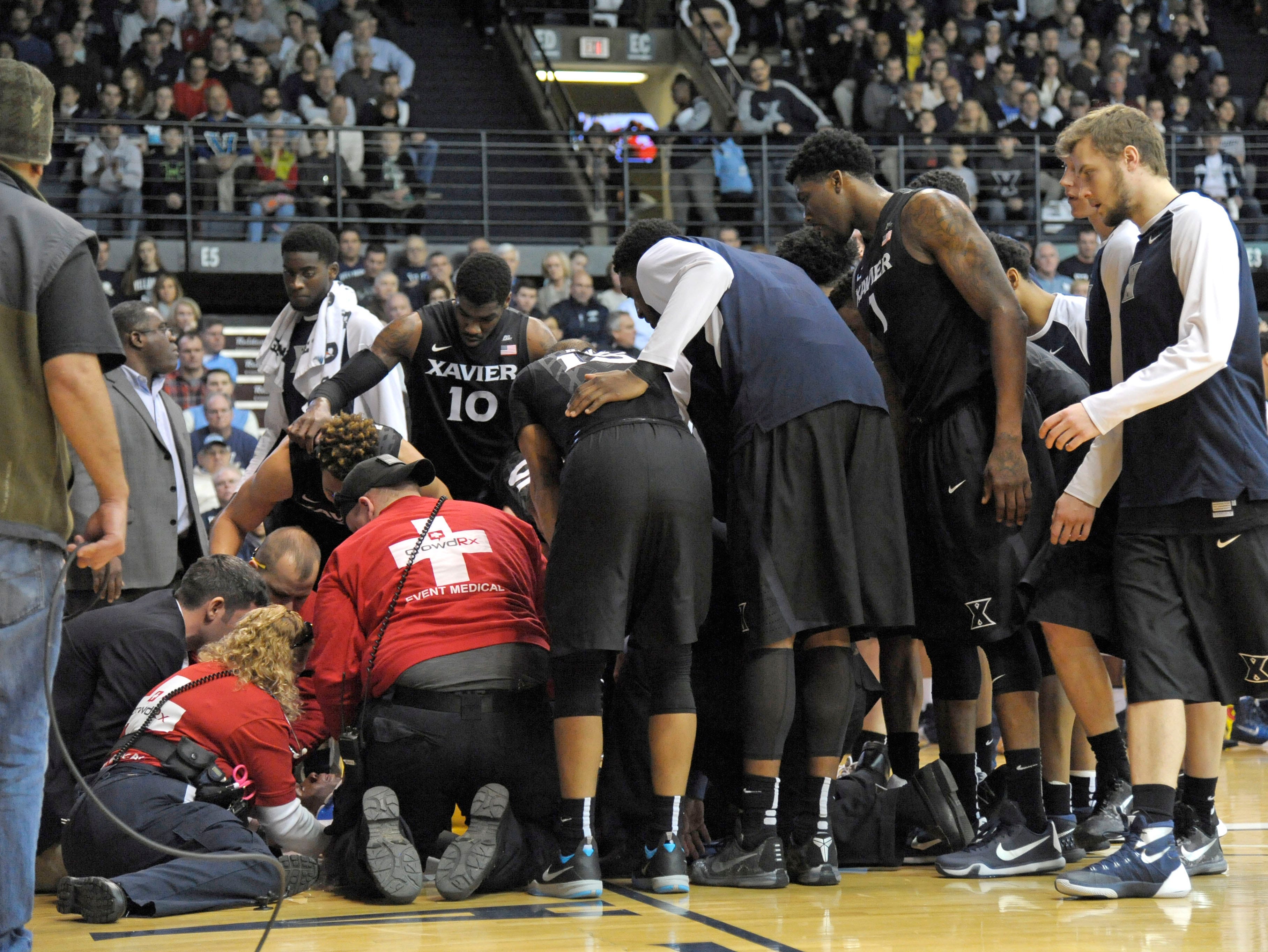 Xavier teammates gather around Edmond Sumner after his hard fall against the Villanova Wildcats at The Pavilion on Dec. 31, 2015. Xavier head coach Chris Mack on the scary scene: "We weren't sure for the rest of the game if he was paralyzed or not. It shook us all."