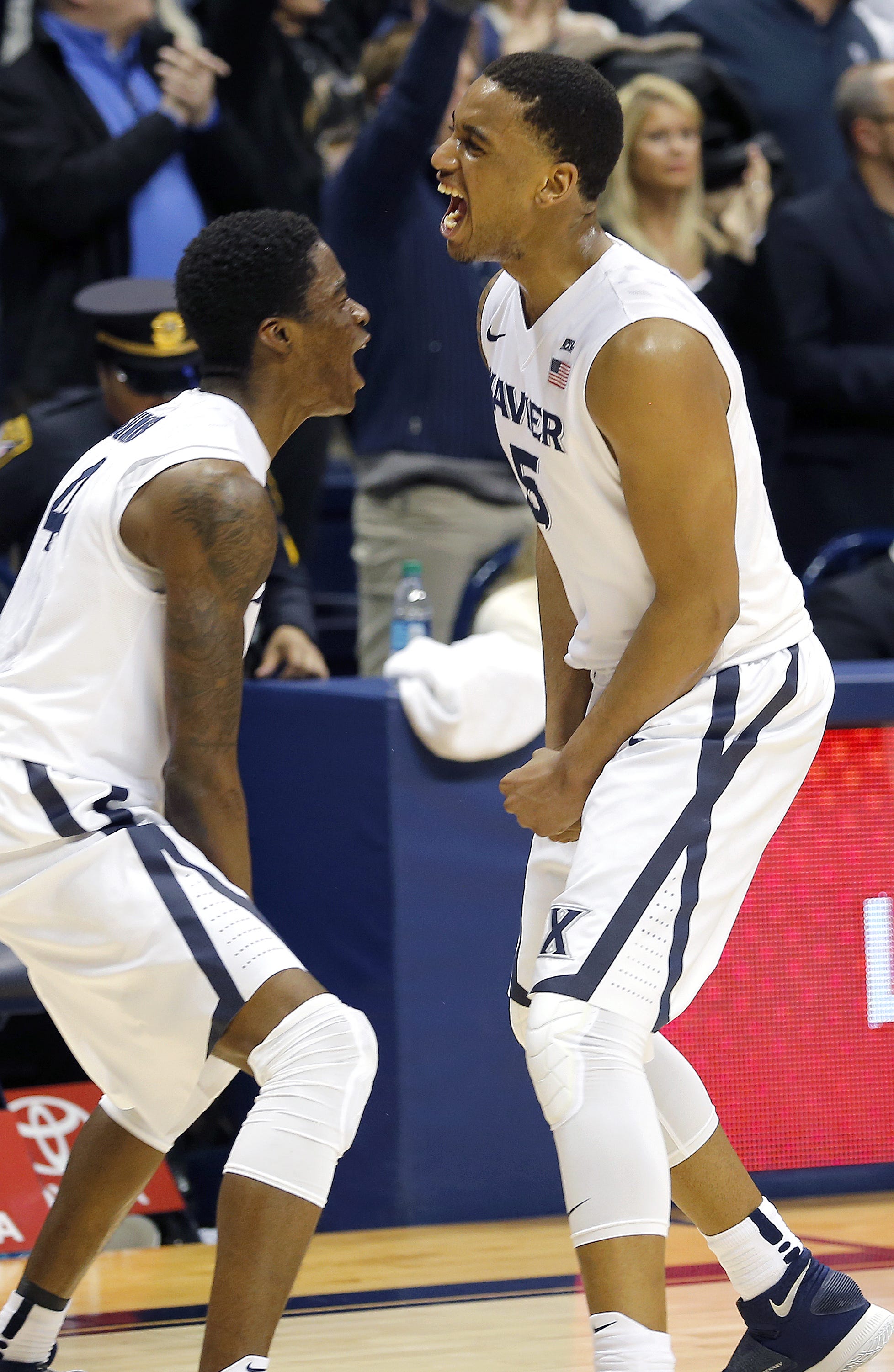 Xavier's Edmond Sumner, left, and Trevon Bluiett celebrate beating No. 1 Villanova at the Cintas Center Wednesday, February 24, 2016. Xavier won 90-83.
