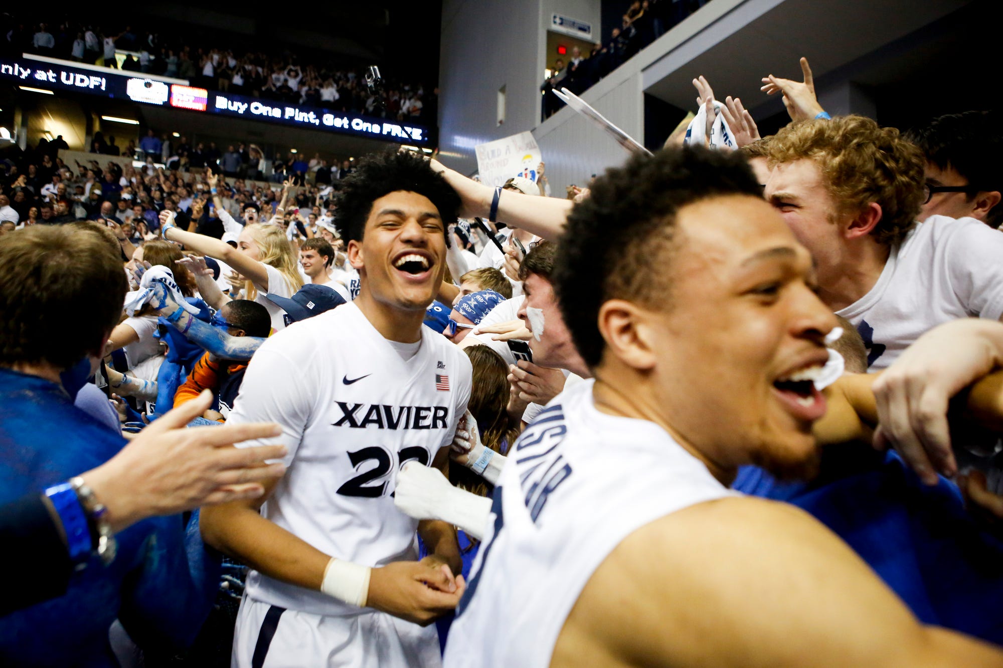 Kaiser Gates (left) and Larry Austin Jr. celebrate after Xavier beat Villanova 90-83 at the Cintas Center Wednesday, February 24, 2016.