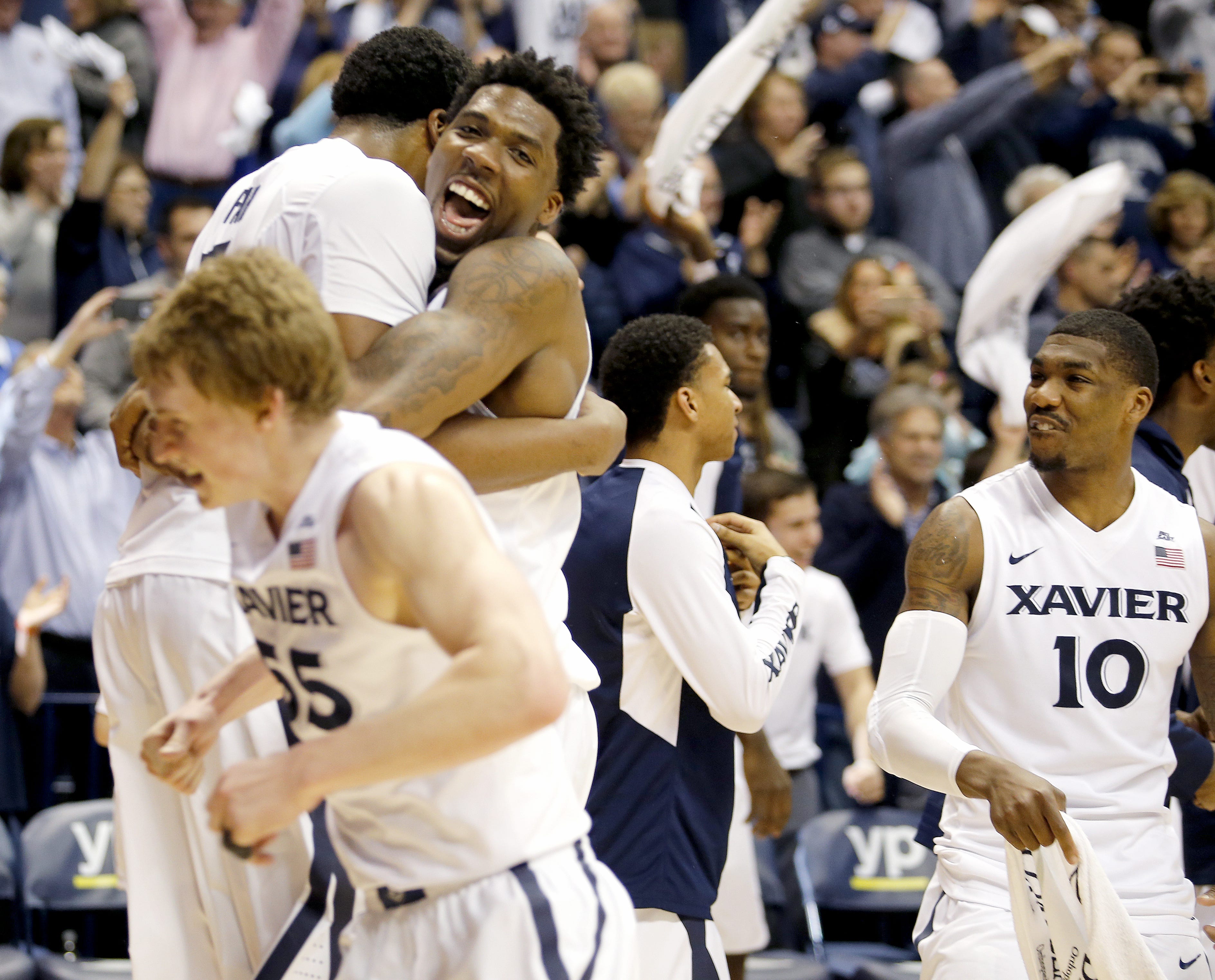 Xavier James Farr (back left), Jalen Reynolds, (facing camera) J.P. Macura (foreground) and Remy Abell (right) celebrate after the Musketeers beat No. 1 Villanova at the Cintas Center Wednesday, February 24, 2016. Xavier won 90-83.