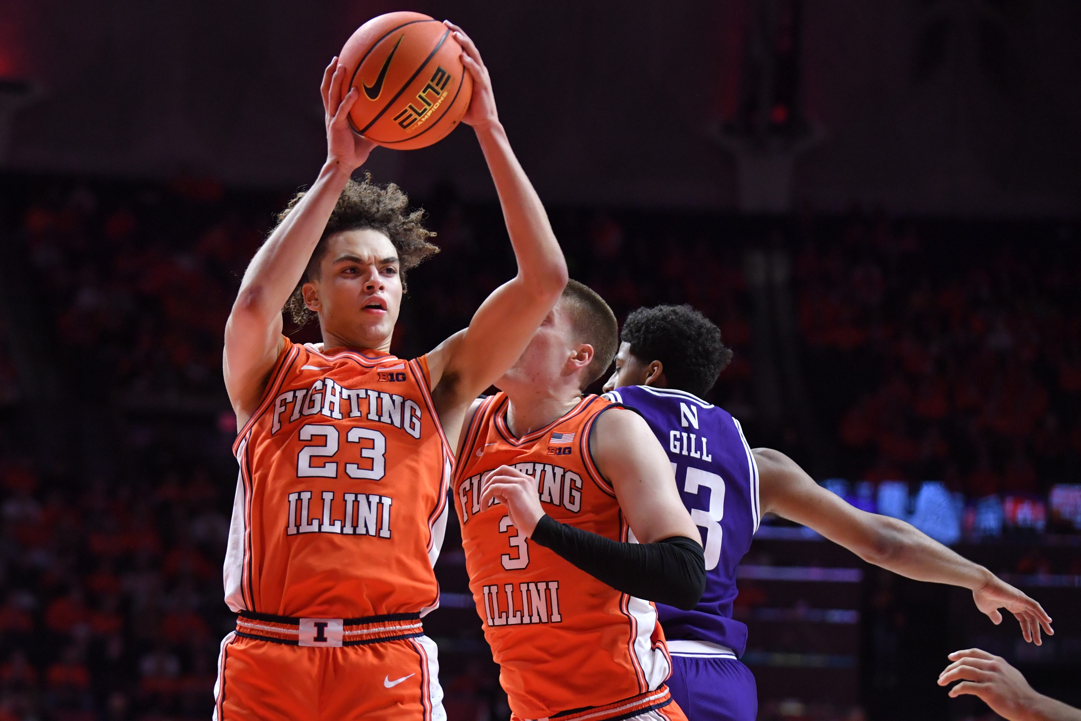 Champaign, Illinois, USA; Illinois Fighting Illini guard Keaton Wagler (23) grabs a rebound during the second half against the Northwestern Wildcats at State Farm Center.