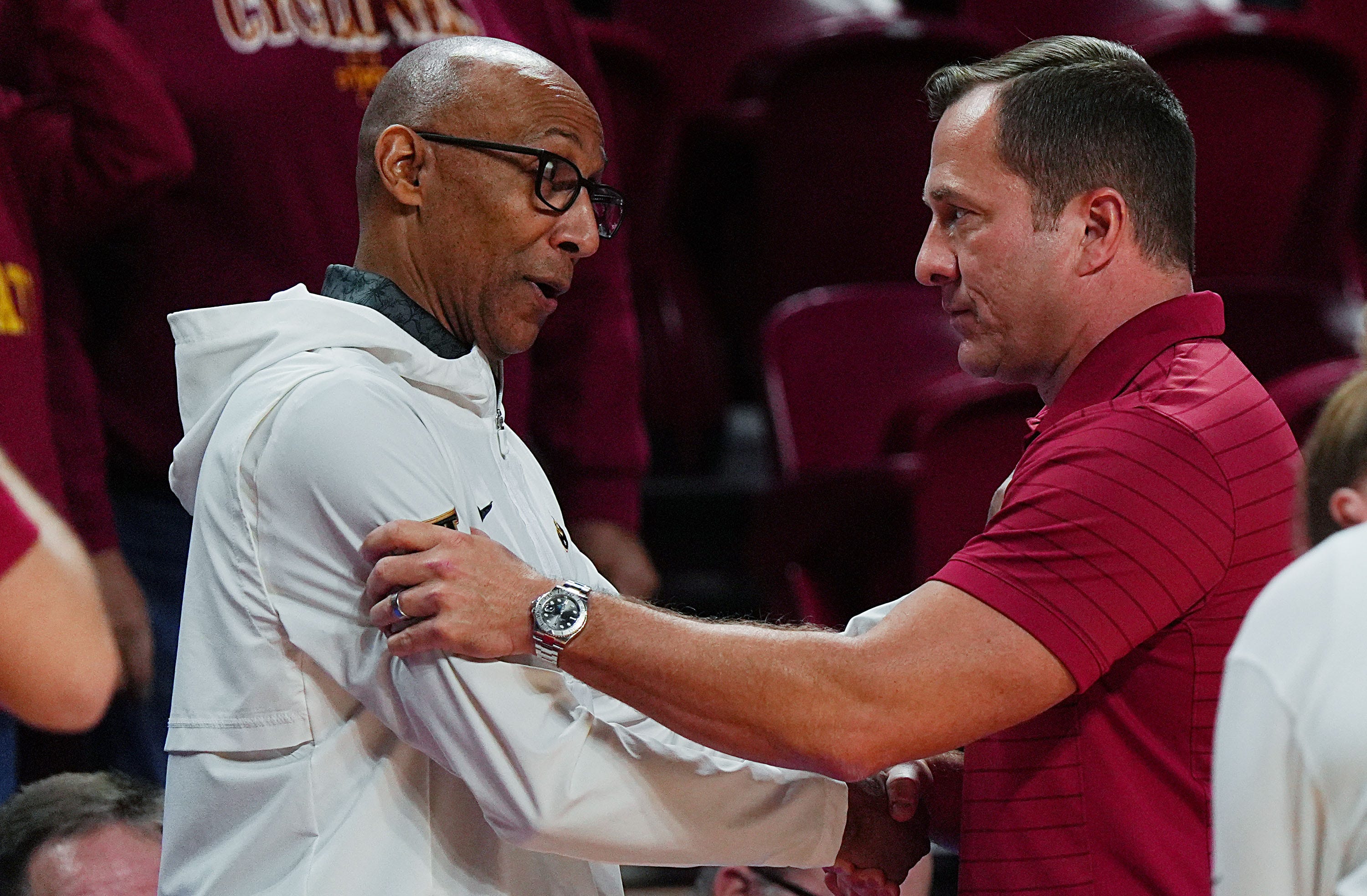 Iowa State Cyclones men's basketball head coach T.J. Otzelberger greets UCF Knights men's basketball head coach Johnny Dawkins before Iowa State and UCF men’s basketball on Jan. 20, 2026, at Hilton Coliseum in Ames, Iowa.