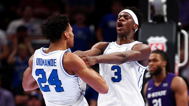 BYU forward AJ Dybantsa (3) celebrates with forward Dominique Diomande (24) after scoring a fast break dunk to take a 50-49 lead into halftime of the game against the Kansas State Wildcats during the 2026 Phillips 66 Big 12 Men's Basketball Tournament at the T-Mobile Center in Kansas City, Missouri, on Tuesday, March 10, 2026.