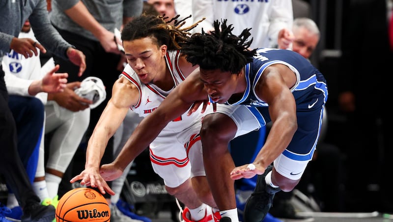Houston Cougars guard Kingston Flemings (4) and BYU guard Robert Wright III (1) dive for a loose ball during the first half of the quarterfinal of the 2026 Phillips 66 Big 12 Men's Basketball Tournament at the T-Mobile Center in Kansas City, Missouri, on Thursday, March 12, 2026.