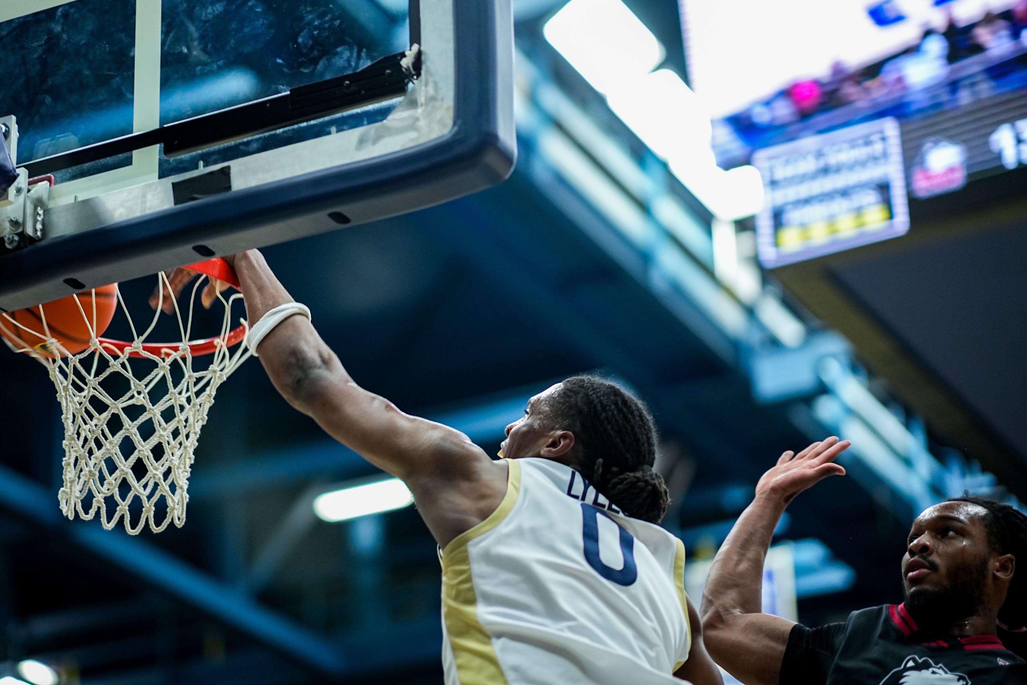 Akron Zips’ Amani Lyles (0) dunks during a Mid American Conference men’s basketball game against NIU, March 6, 2026, at James A Rhodes Arena in Akron, Ohio.