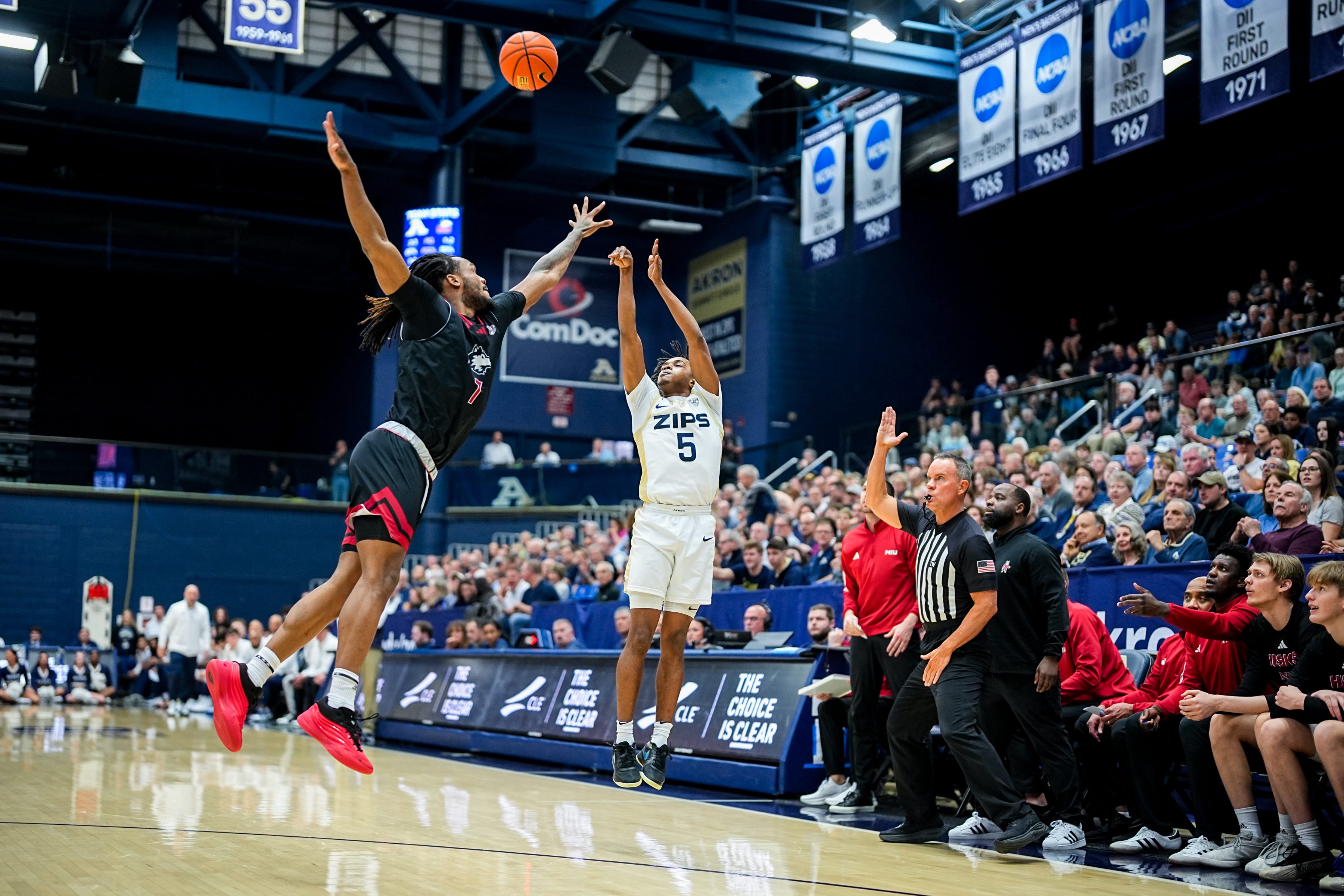 Akron Zips’ Tavari Johnson (5) shoots for three points over NIU’s Hassan 'Tre' Washington (7) during a Mid American Conference men’s basketball game, March 6, 2026, at James A Rhodes Arena in Akron, Ohio.