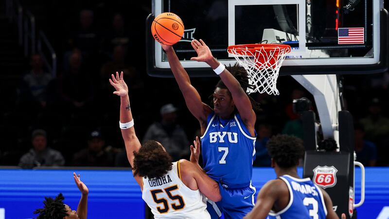 BYU forward Khadim Mboup (7) blocks a lay up attempt by West Virginia Mountaineers center Harlan Obioha (55) during the second half of the game in the second round of the 2026 Phillips 66 Big 12 Men's Basketball Tournament at the T-Mobile Center in Kansas City, Missouri, on Wednesday, March 11, 2026.