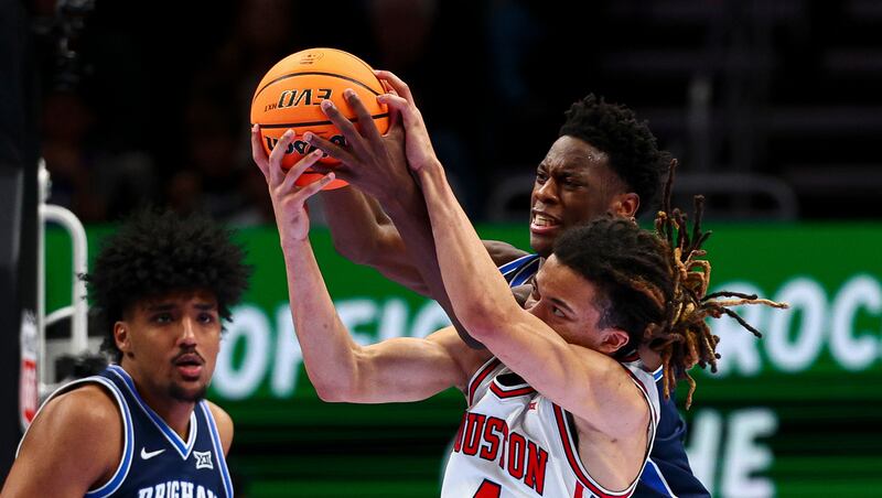 BYU forward AJ Dybantsa (3) and Houston Cougars guard Kingston Flemings (4) fight for a rebound during the second half of the quarterfinal of the 2026 Phillips 66 Big 12 Men's Basketball Tournament at the T-Mobile Center in Kansas City, Missouri, on Thursday, March 12, 2026.