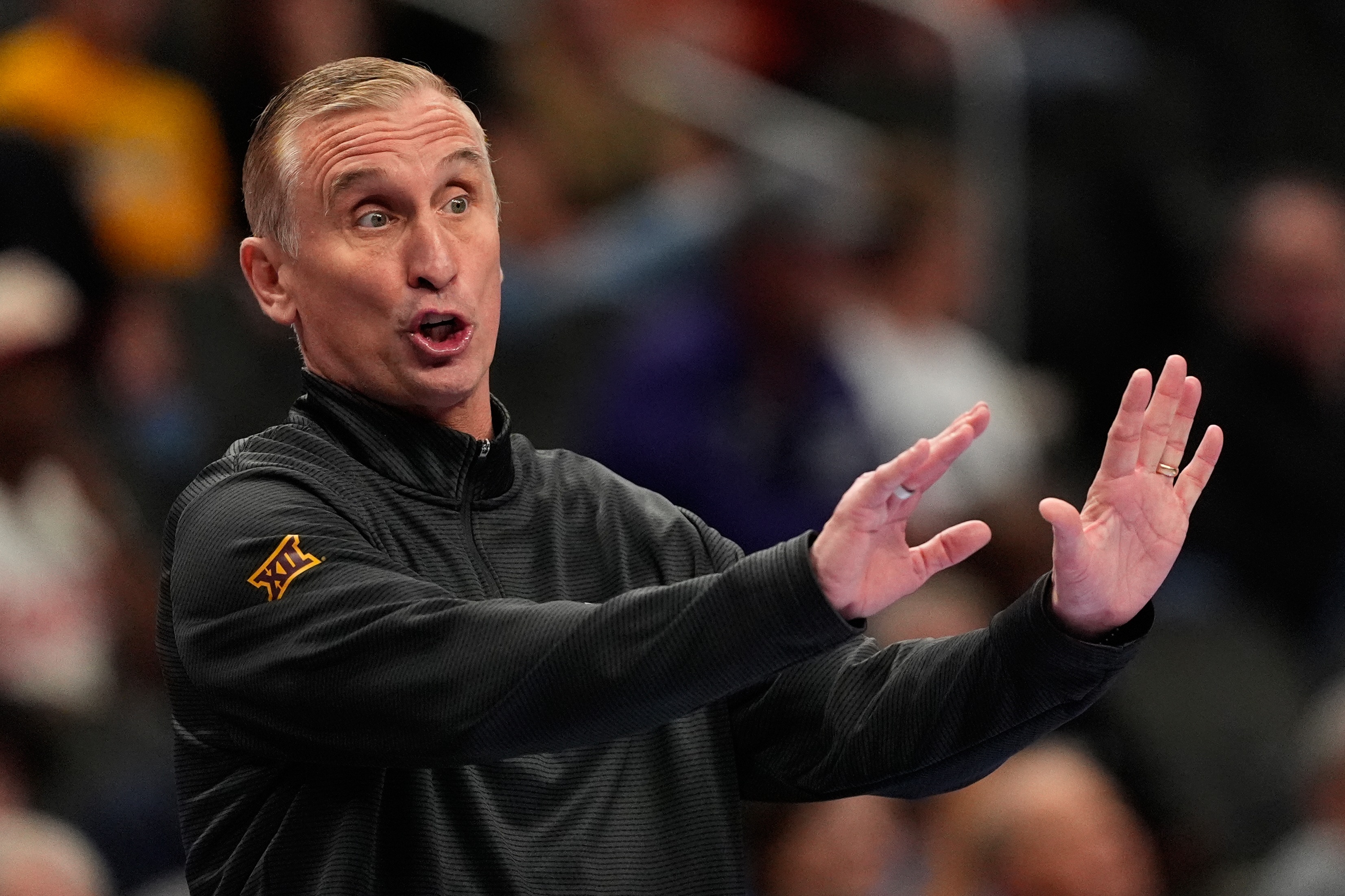 Arizona State head coach Bobby Hurley motioning to his players.