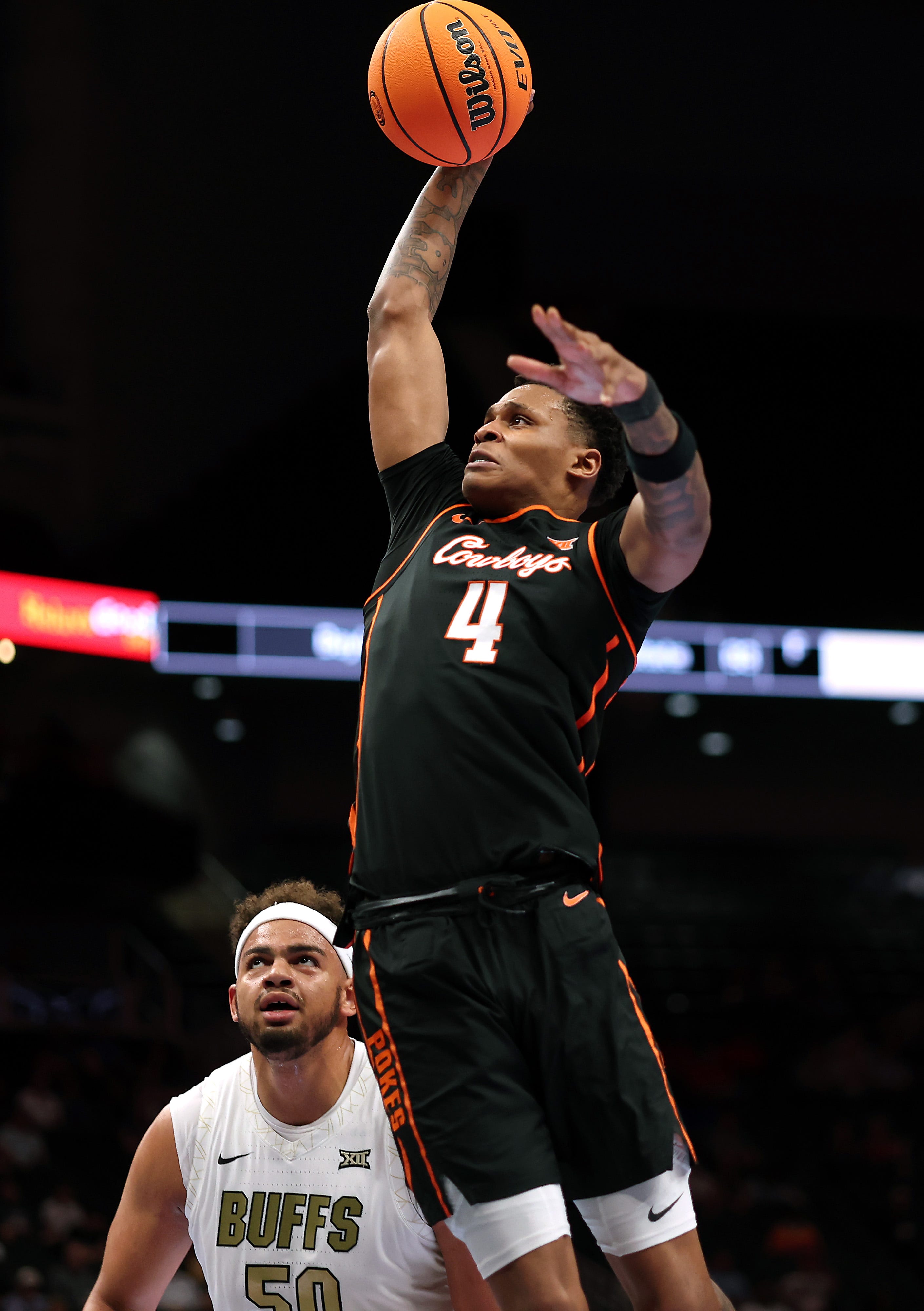 KANSAS CITY, MISSOURI - MARCH 10: Christian Coleman #4 of the Oklahoma State Cowboys goes up for a dunk as Elijah Malone #50 of the Colorado Buffaloes defends during the first round game of the Men's 2026 Big 12 Tournament at T-Mobile Center on March 10, 2026 in Kansas City, Missouri. (Photo by Jamie Squire/Getty Images)