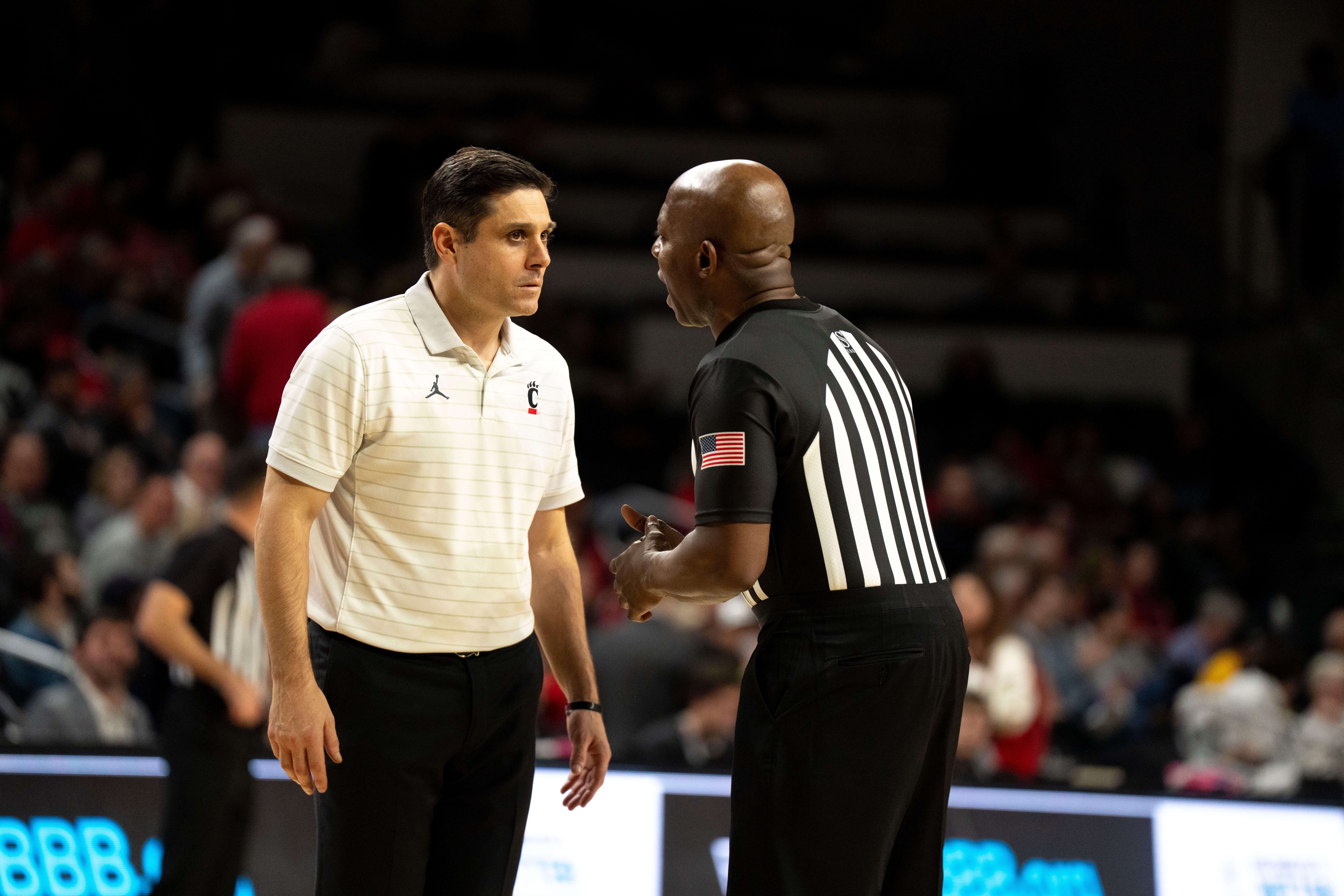 Cincinnati Bearcats head coach Wes Miller speaks with a referee in the second half of the NCAA basketball game against the Lipscomb Bisons at Fifth Third Arena in Cincinnati on Dec. 29, 2025.
