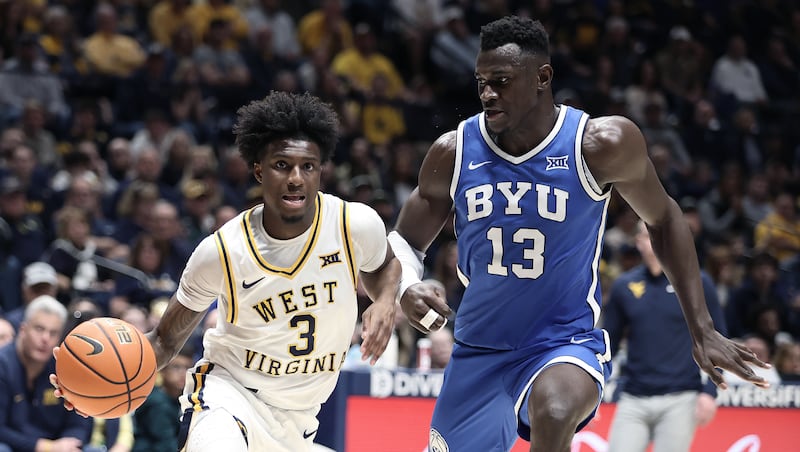West Virginia guard Honor Huff (3) is defended by BYU center Keba Keita (13) during game Saturday, Feb. 28, 2026, in Morgantown, W.Va.