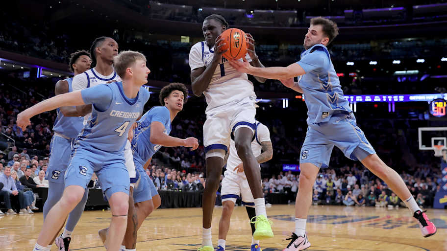 Pirates guard Jacob Dar (1) grabs a rebound against Creighton Bluejays guard Josh Dix (4) and forward Jasen Green (0).