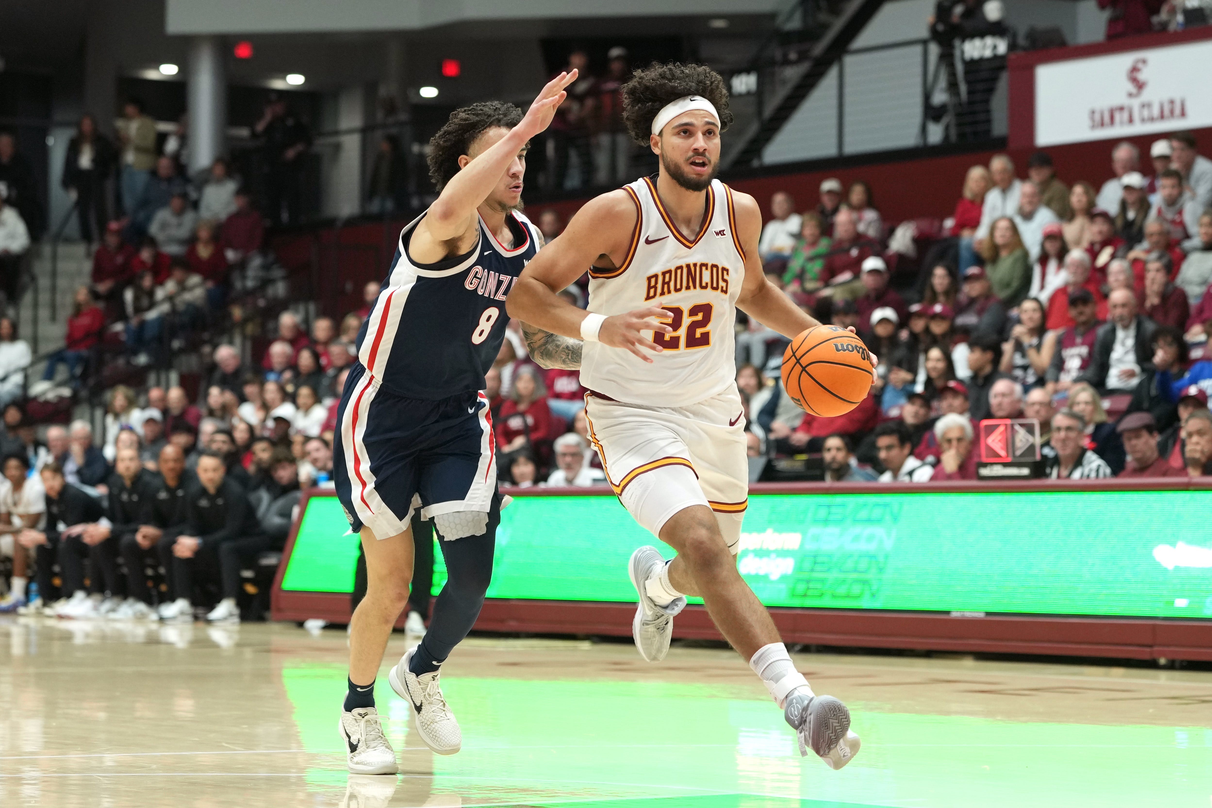 Feb 14, 2026; Santa Clara, California, USA; Santa Clara Broncos forward Allen Graves (22) dribbles against Gonzaga Bulldogs guard Jalen Warley (8) during the first half at Leavey Center. Mandatory Credit: Darren Yamashita-Imagn Images