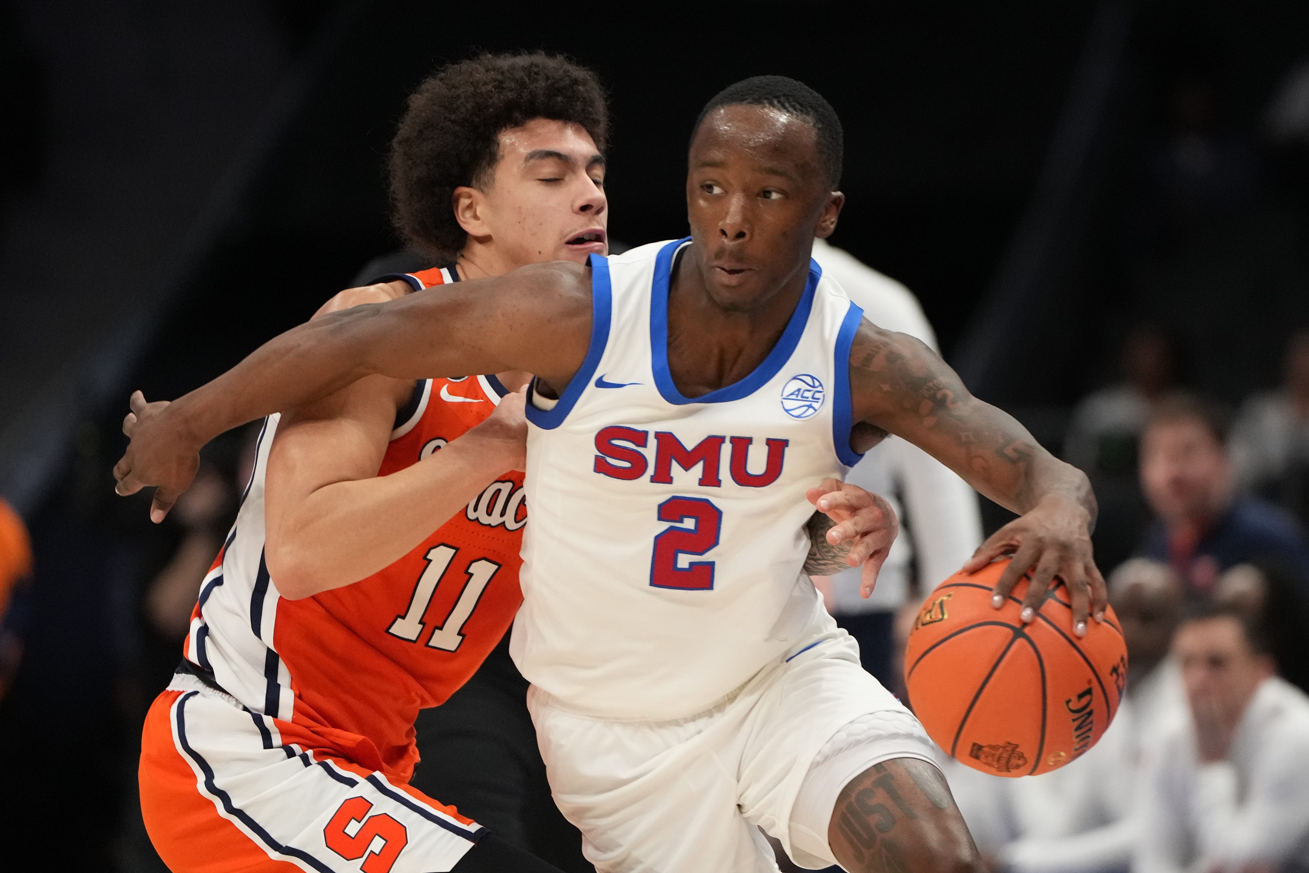 SMU guard Boopie Miller (2) dribbles the ball as Syracuse guard Naithan George (11) defends during the 2026 ACC tournament game at Spectrum Center in Charlotte, N.C.