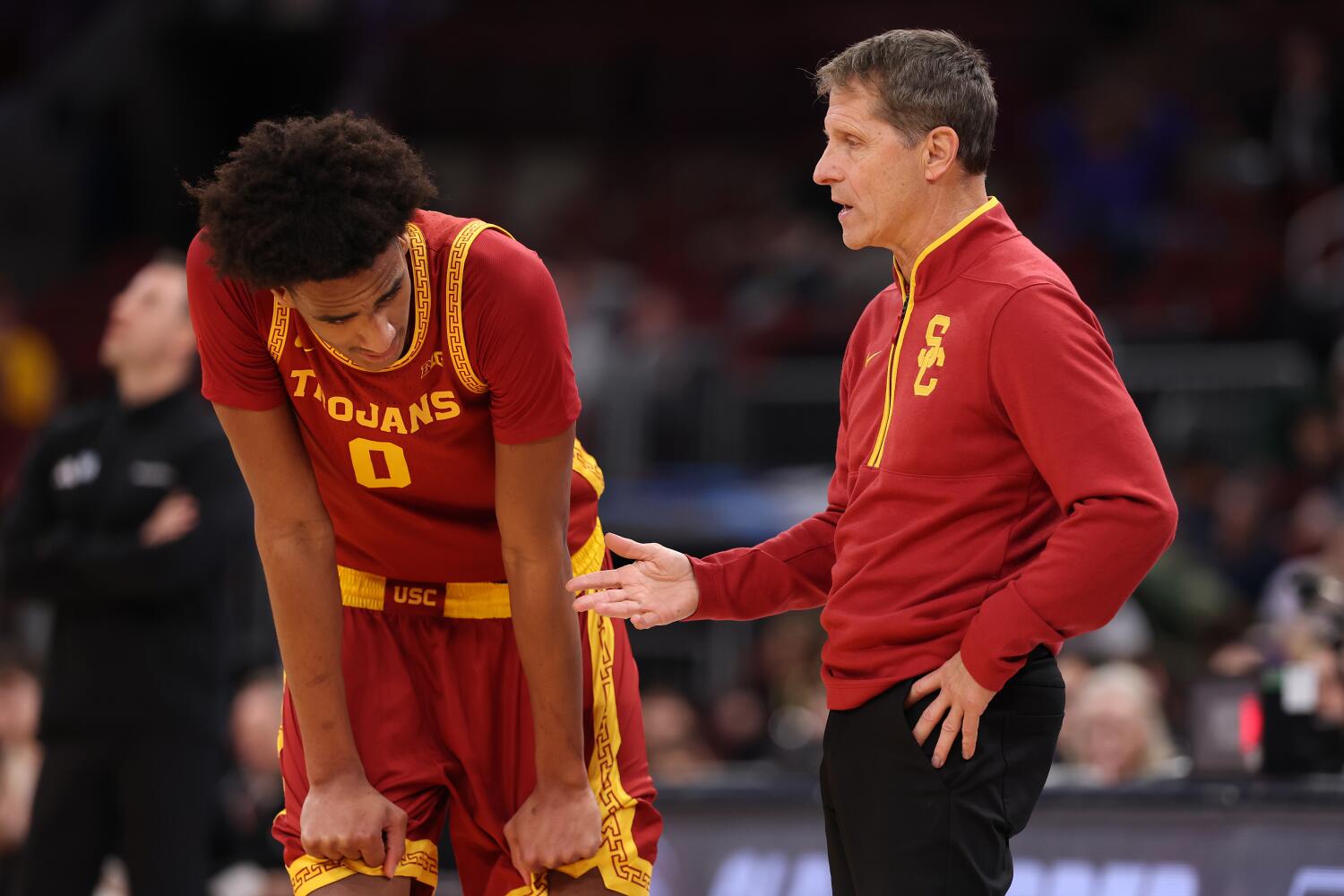 USC guard Alijah Arenas leans over and rests his hands on his thighs while talking with coach Eric Musselman.
