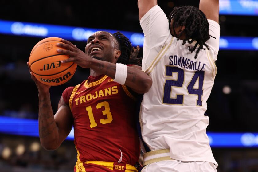 USC's Kam Woods drives past Washington's Lathan Sommerville during the Trojans' loss during the Big Ten tournament.