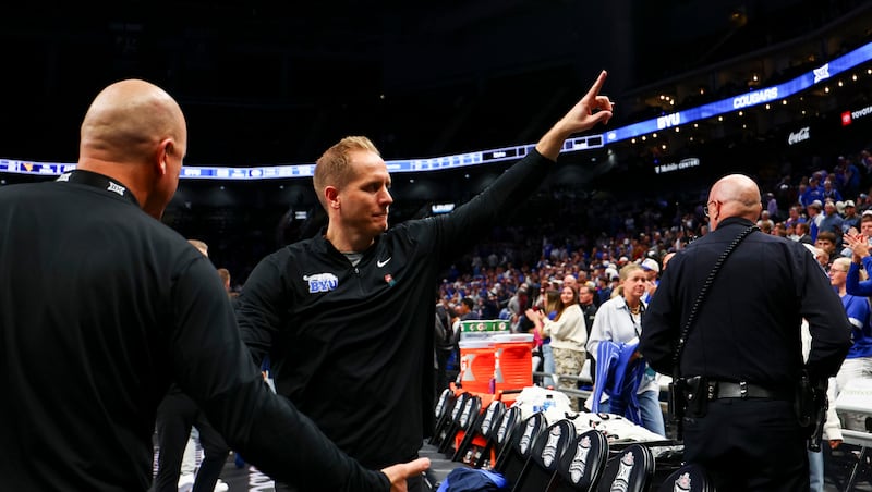 BYU head coach Kevin Young waves to the fans as he exits the court after BYU defeated the West Virginia Mountaineers 68-48 in the second round of the 2026 Phillips 66 Big 12 Men's Basketball Tournament at the T-Mobile Center in Kansas City, Missouri, on Wednesday, March 11, 2026.