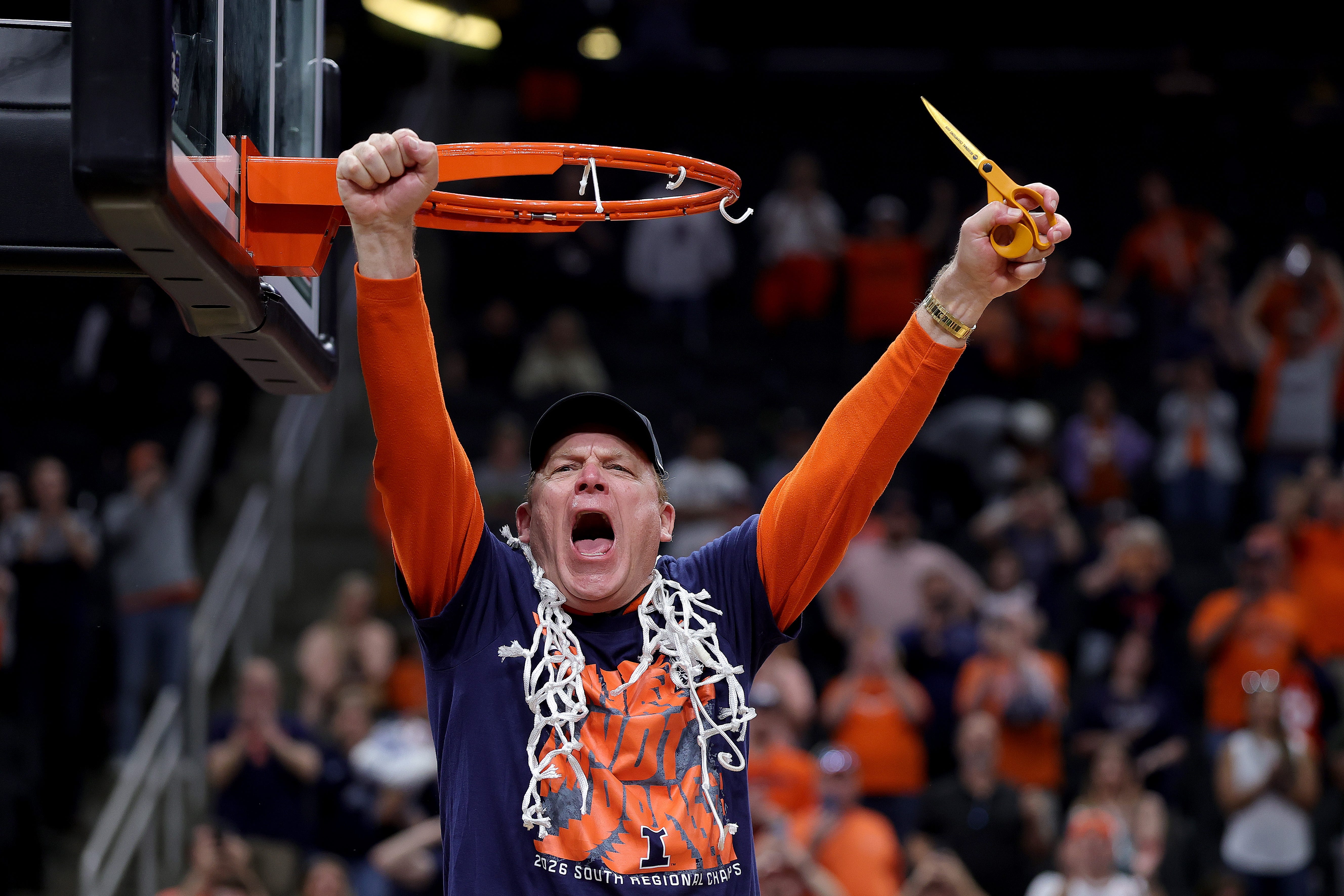 Head coach Brad Underwood of the Illinois Fighting Illini celebrates cutting down the net after defeating the Iowa Hawkeyes in the Elite Eight of the 2026 NCAA Men's Basketball Tournament at Toyota Center on March 28, 2026 in Houston, Texas.
