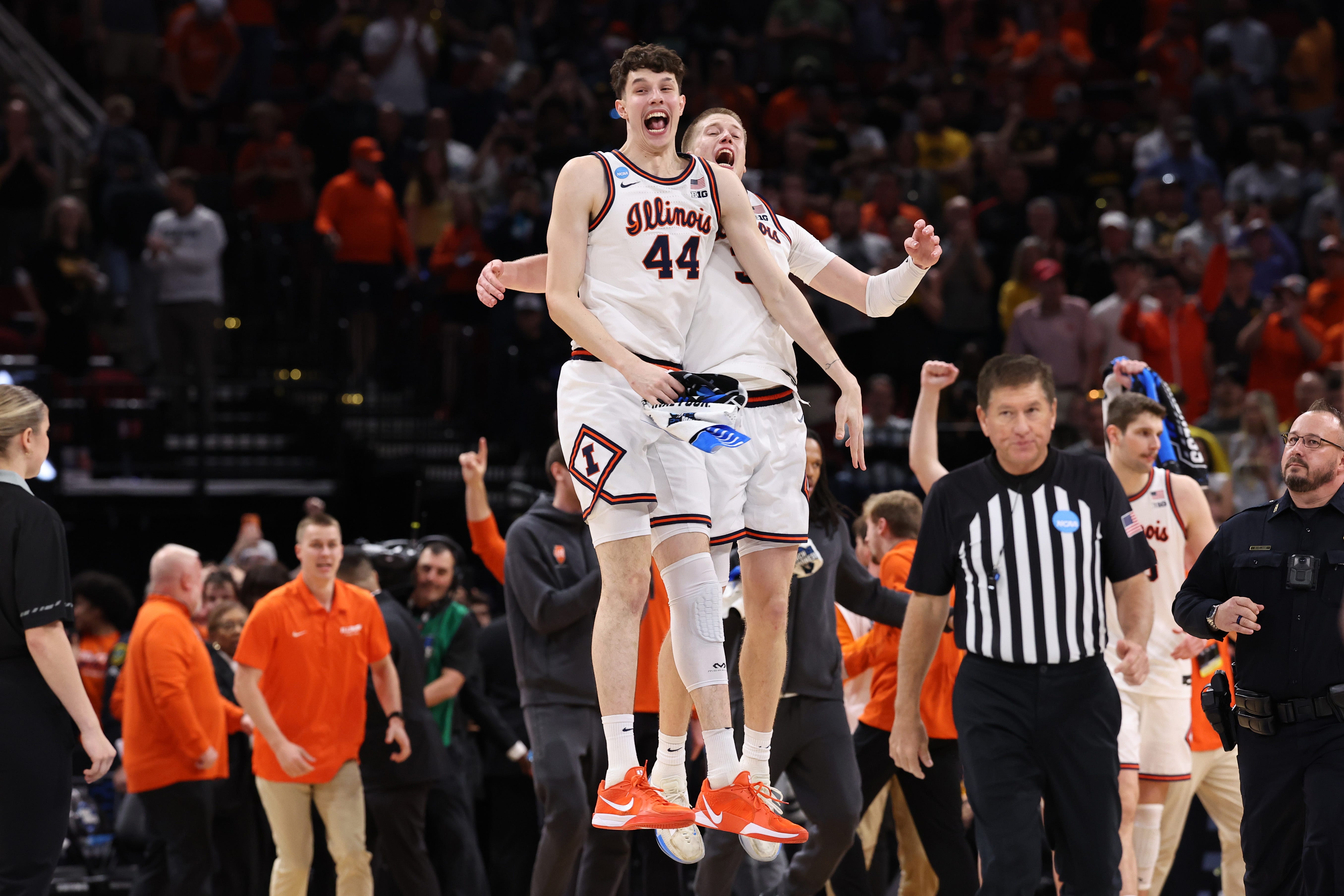 Illinois Fighting Illini center Zvonimir Ivisic (44) and forward Ben Humrichous (3) celebrate after defeating the Iowa Hawkeyes in an Elite Eight game of the South Region of the men's 2026 NCAA Tournament at Toyota Center.