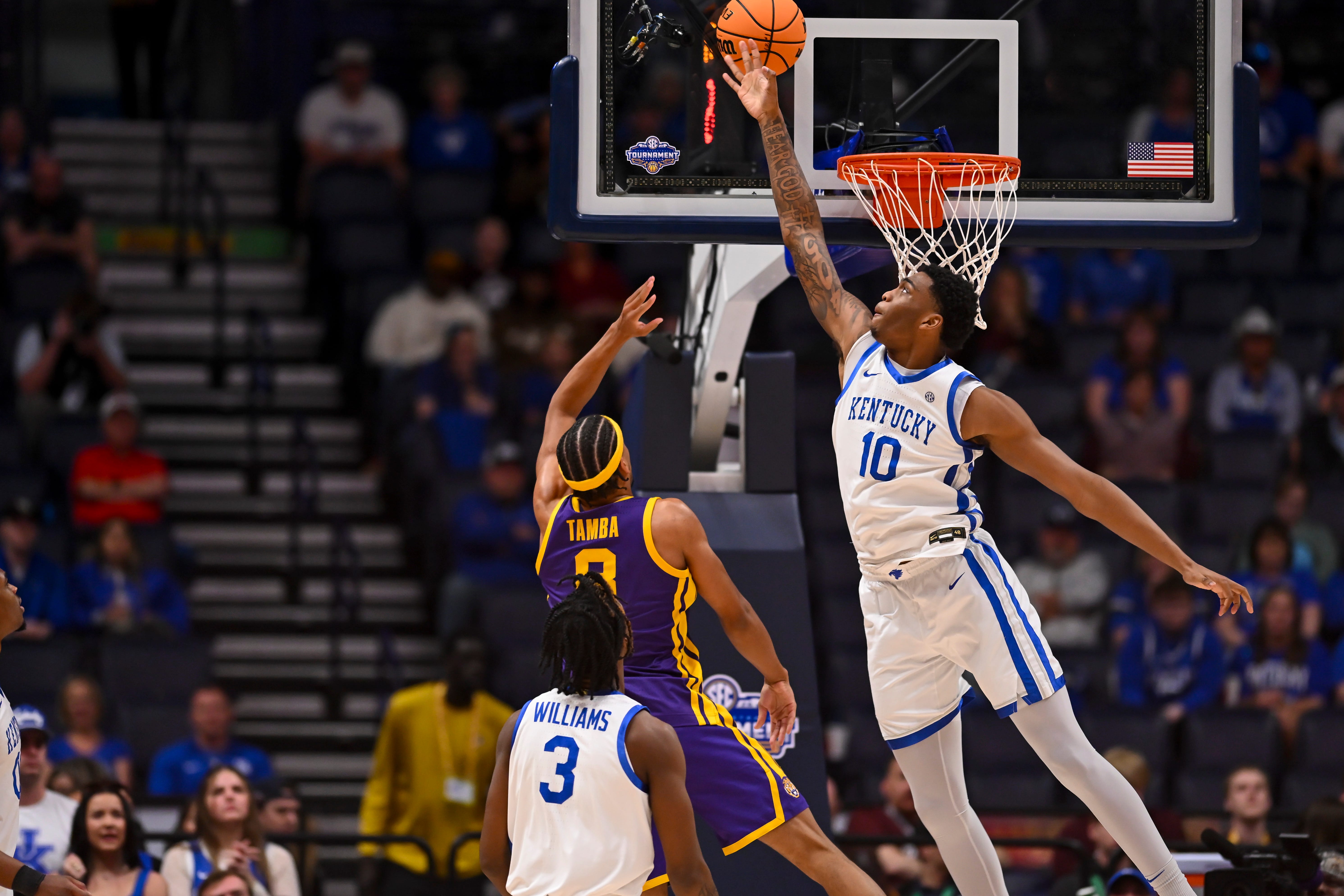Mar 11, 2026; Nashville, TN, USA; Kentucky Wildcats forward Brandon Garrison (10) blocks the shot of Louisiana State Tigers forward Pablo Tamba (8) during the first half at Bridgestone Arena. Mandatory Credit: Steve Roberts-Imagn Images