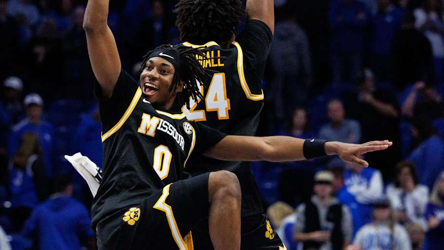 Missouri Tigers guard Anthony Robinson II (0) and forward Nicholas Randall (24) celebrate after winning the game