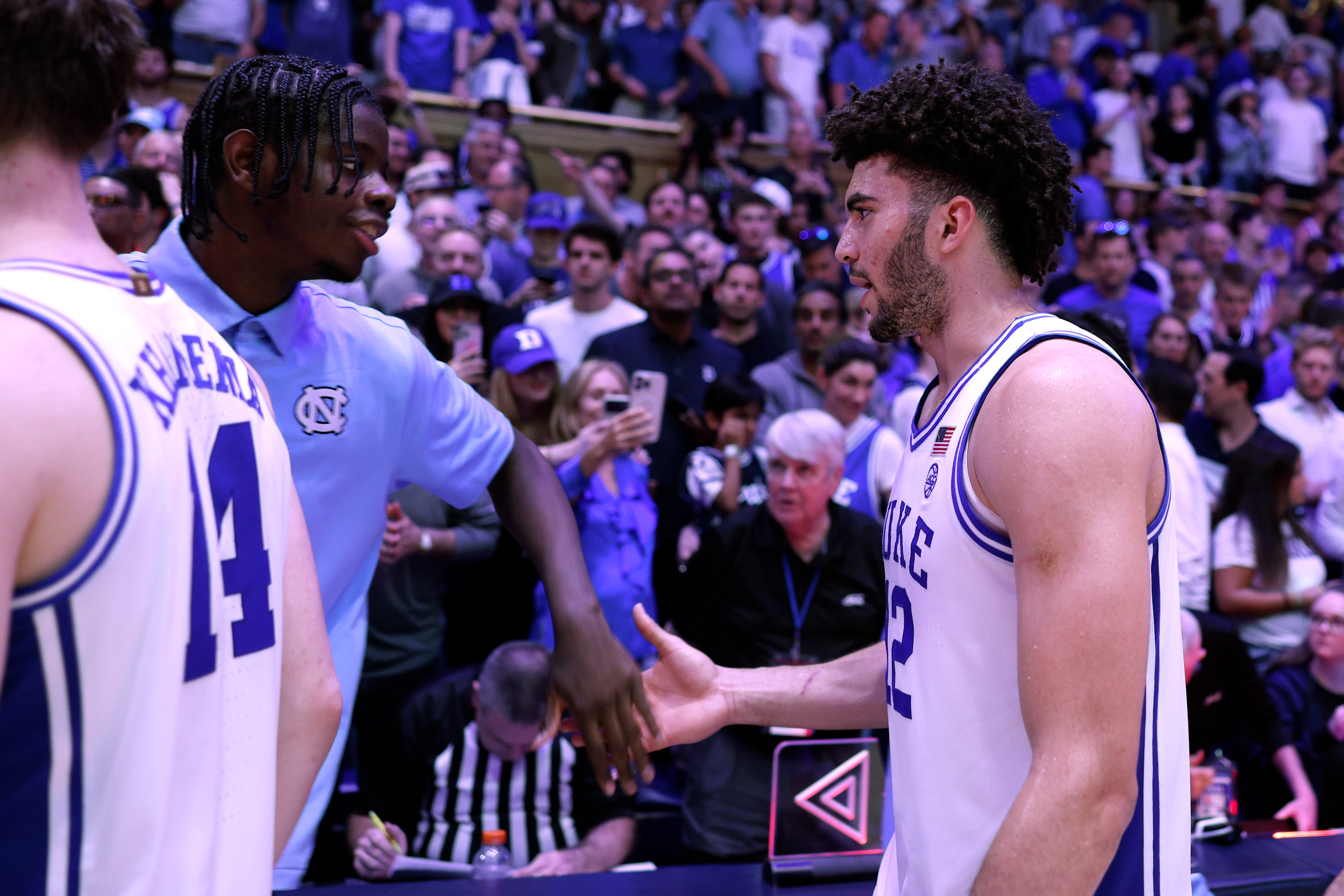 DURHAM, NORTH CAROLINA - MARCH 7: Cameron Boozer #12 of the Duke Blue Devils shakes hands with Caleb Wilson #8 of the North Carolina Tar Heels following their game at Cameron Indoor Stadium on March 7, 2026 in Durham, North Carolina. (Photo by Lance King/Getty Images)