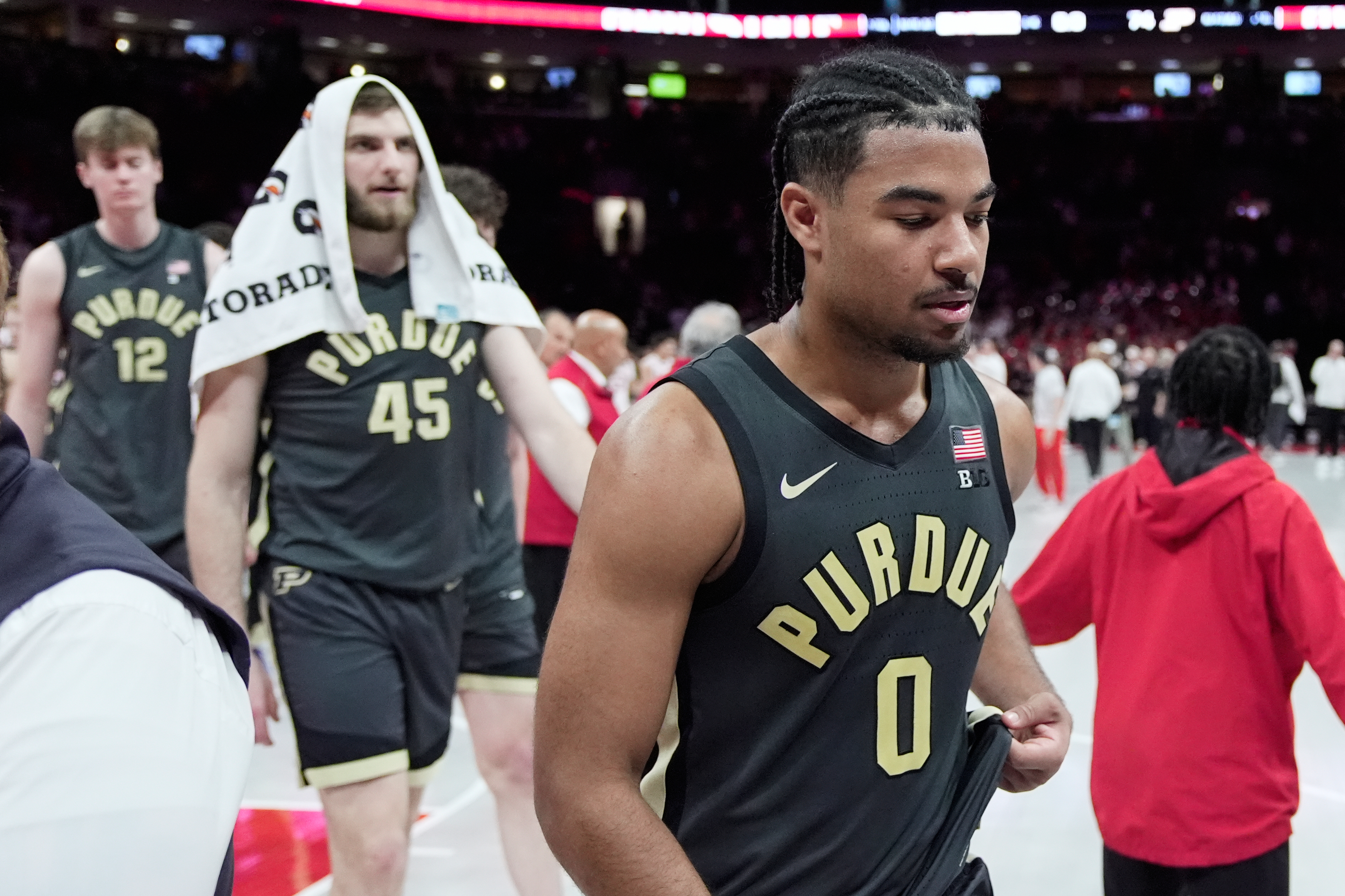Purdue's Daniel Jacobsen (12), Oscar Cluff (45) and C.J. Cox (0) walk off the court after being defeated by Ohio State in an NCAA college basketball game Sunday, March 1, 2026, in Columbus, Ohio. (AP Photo/Sue Ogrocki)